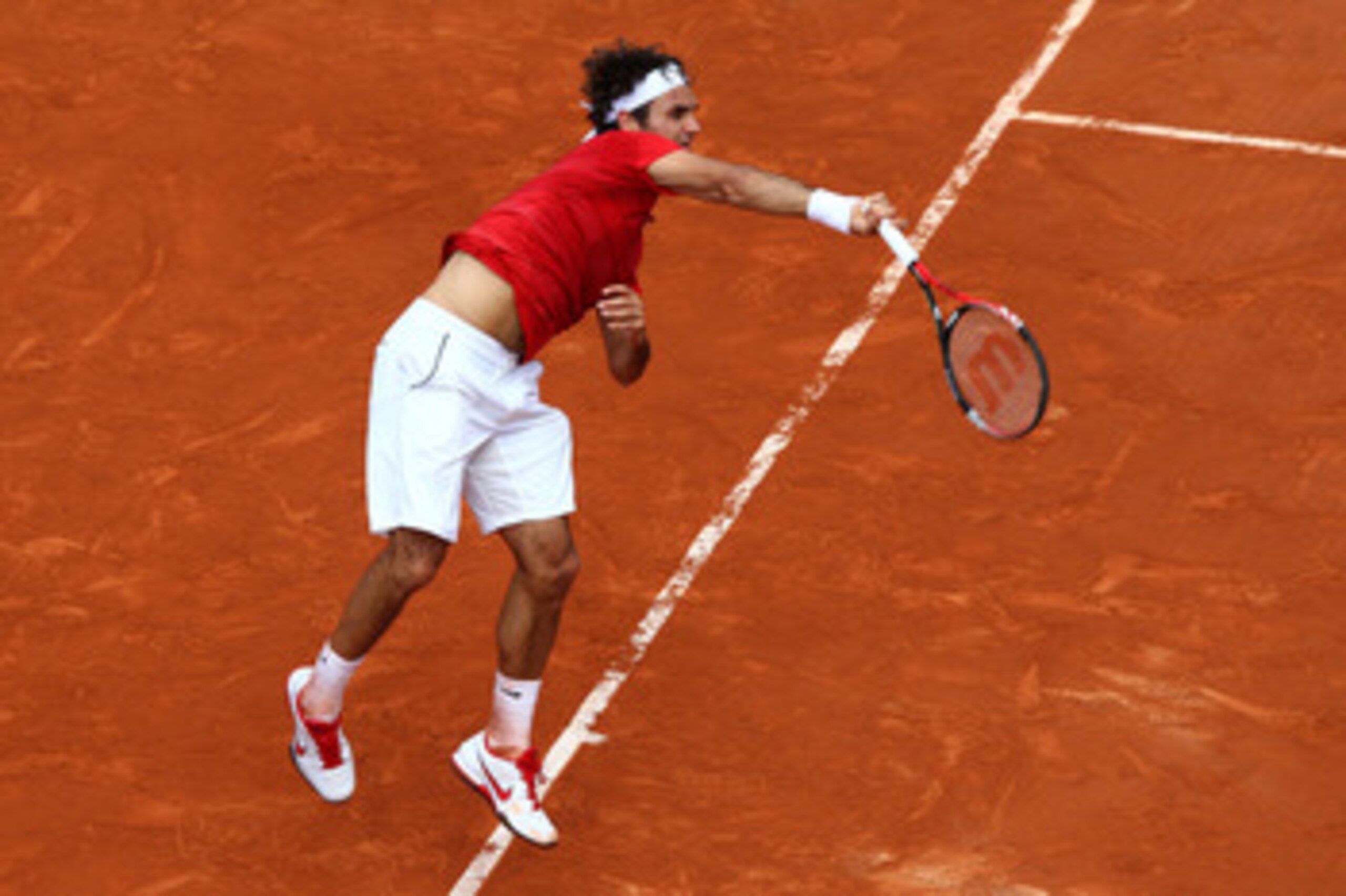 PARIS, FRANCE - JUNE 05:  Roger Federer of Switzerland serves during the men's singles final match between Rafael Nadal of Spain and Roger Federer of Switzerland on day fifteen of the French Open at Roland Garros on June 5, 2011 in Paris, France.  (Photo