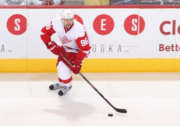 GLENDALE, AZ - APRIL 18:  Tomas Holmstrom #96 of the Detroit Red Wings skates with the puck in Game Three of the Western Conference Quarterfinals against the Phoenix Coyotes during the 2011 NHL Stanley Cup Playoffs at Jobing.com Arena on April 18, 2011 in