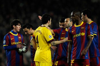 BARCELONA, SPAIN - MARCH 08:  Cesc Fabregas of Arsenal argues with players of Barcelona during the UEFA Champions League round of 16 second leg match between Barcelona and Arsenal at the Camp Nou stadium on March 8, 2011 in Barcelona, Spain. Barcelona won