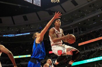 CHICAGO, IL - JANUARY 20: Derrick Rose #1 of the Chicago Bulls goes up for a shot over Dirk Nowitzki #41 of the Dallas Mavericks at the United Center on January 20, 2011 in Chicago, Illinois. The Bulls defeated the Mavericks 82-77. NOTE TO USER: User expr