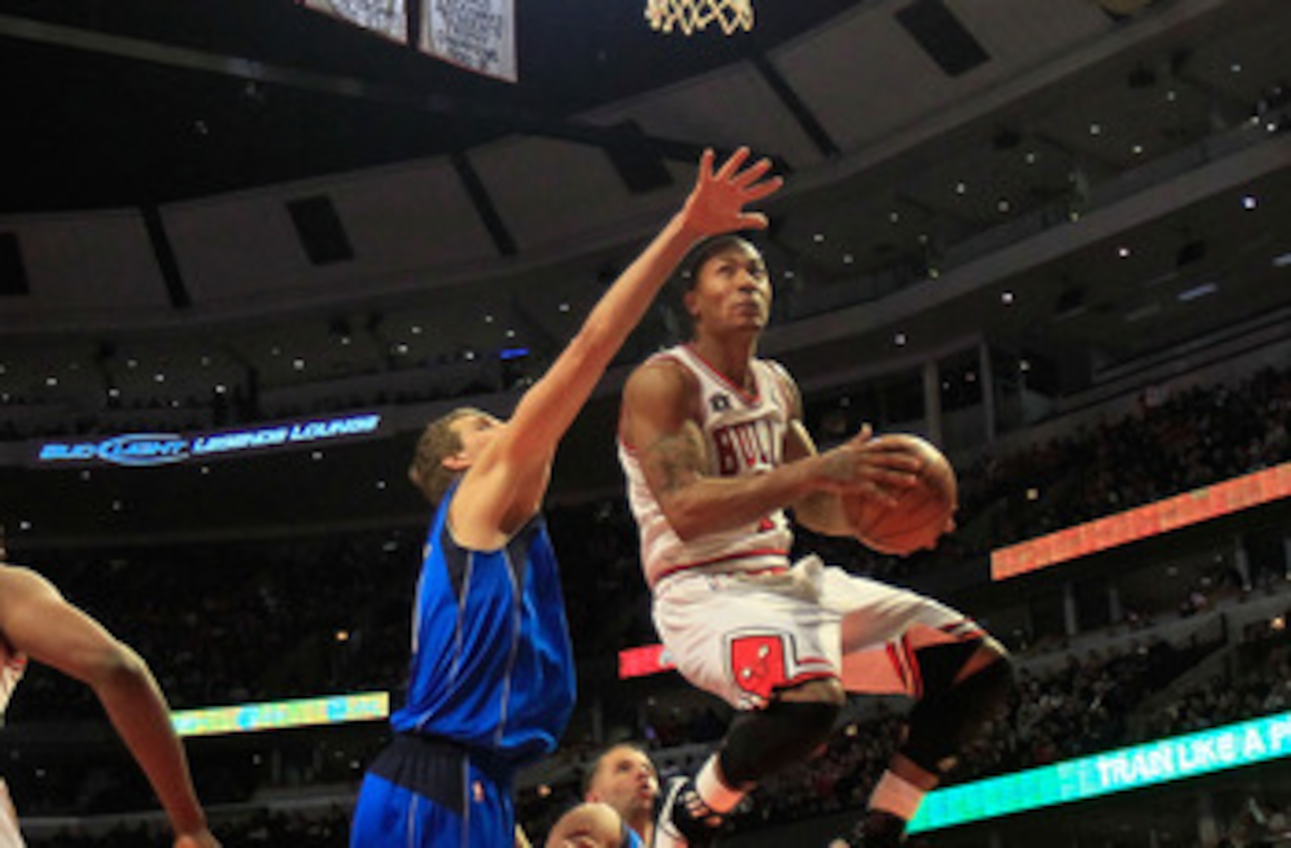 CHICAGO, IL - JANUARY 20: Derrick Rose #1 of the Chicago Bulls goes up for a shot over Dirk Nowitzki #41 of the Dallas Mavericks at the United Center on January 20, 2011 in Chicago, Illinois. The Bulls defeated the Mavericks 82-77. NOTE TO USER: User expr