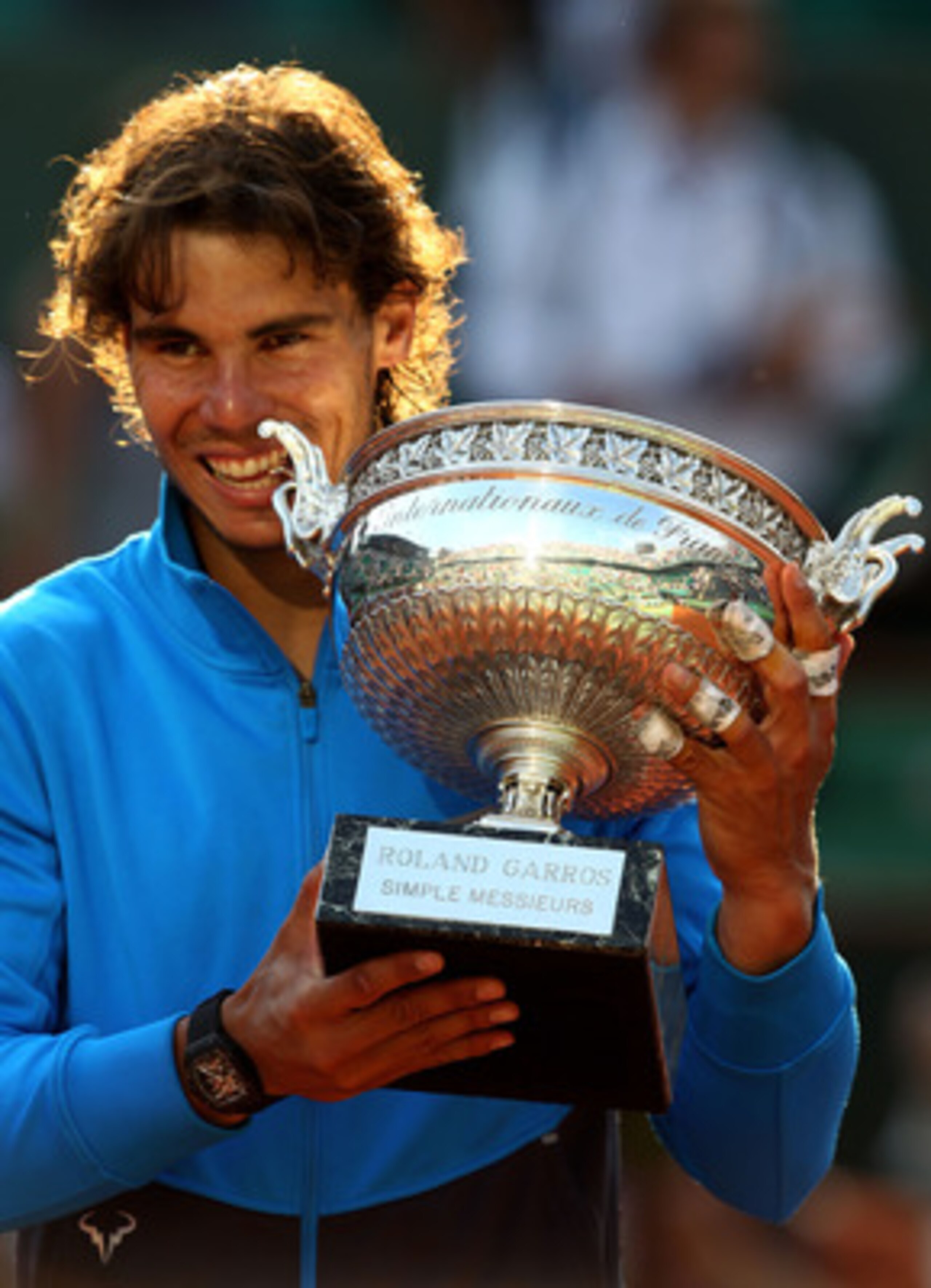 PARIS, FRANCE - JUNE 05:  Champion Rafael Nadal of Spain bites the trophy following his record equalling sixth victory during the men's singles final match between Rafael Nadal of Spain and Roger Federer of Switzerland on day fifteen of the French Open at