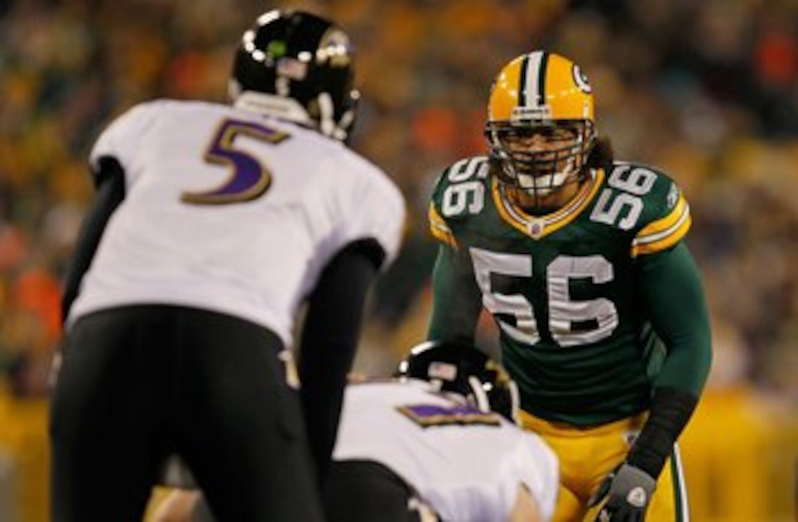 GREEN BAY, WI - DECEMBER 07: Nick Barnett #56 of the Green Bay Packers stares at Joe Flacco #5 of the Baltimore Ravens before the snap at Lambeau Field on December 7, 2009 in Green Bay, Wisconsin. The Packers defeated the Ravens 27-17. (Photo by Jonathan