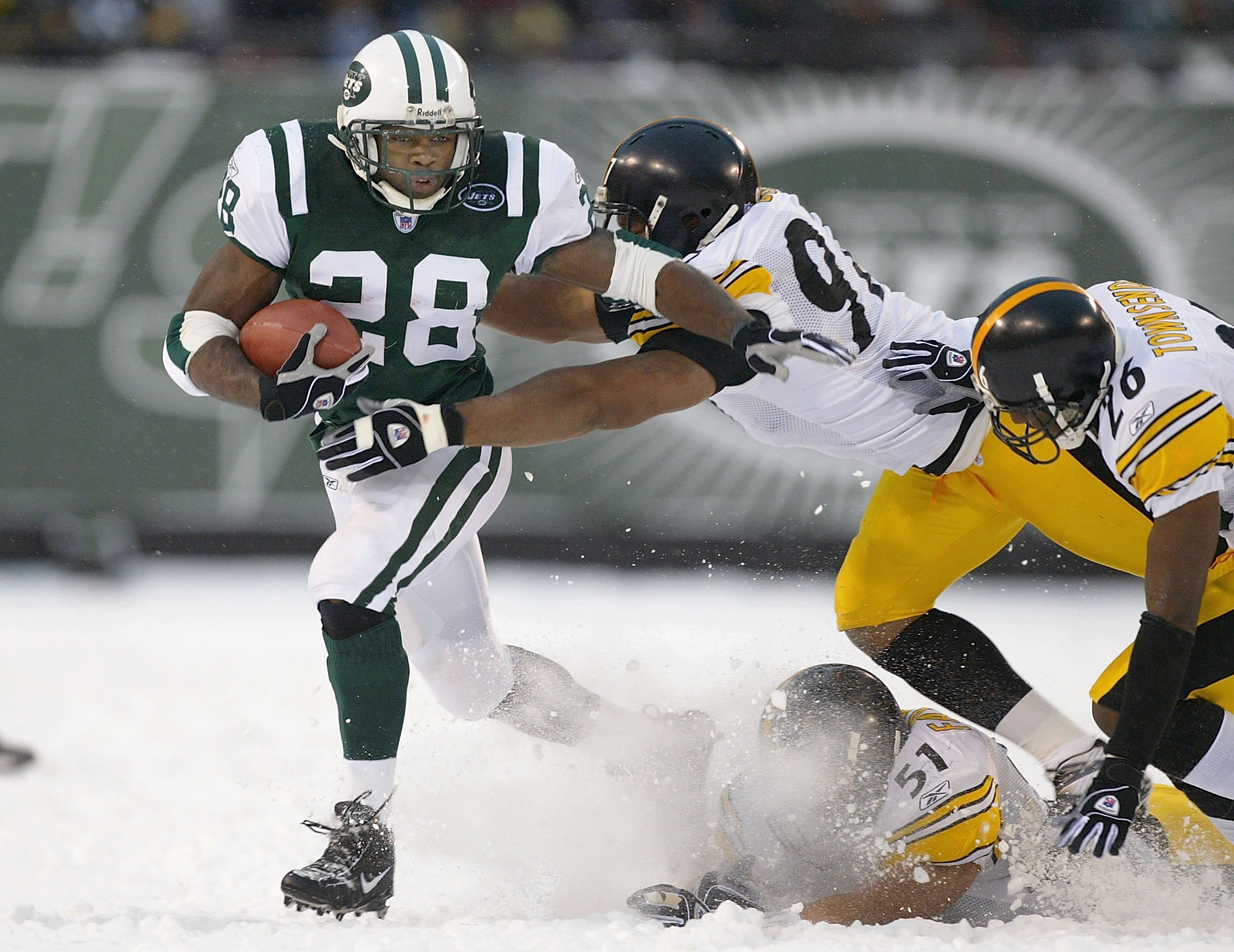 EAST RUTHERFORD, NJ - DECEMBER 14:  Curtis Martin #28 of the New York Jets tries to outrun Kendrell Bell #97, James Farrior #51, and Deshea Townsend #26 of the Pittsburgh Steelers on December 14, 2003 at Giant Stadium in East Rutherford, New Jersey. The J
