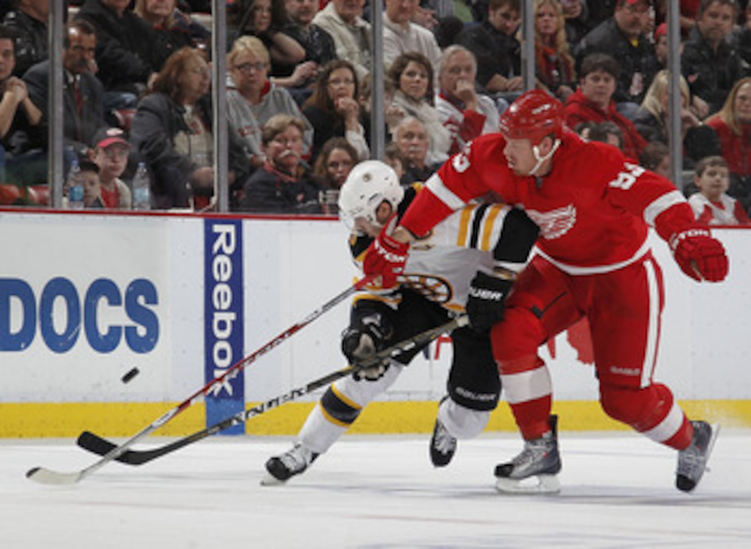 DETROIT, MI - FEBRUARY 13:  David Krejci #46 of the Boston Bruins battles for the puck with Johan Franzen #93 of the of the Detroit Red Wings on February 13, 2011 at Joe Lewis Arena in Detroit, Michigan. Detroit won the game 4-2.  (Photo by Gregory Shamus