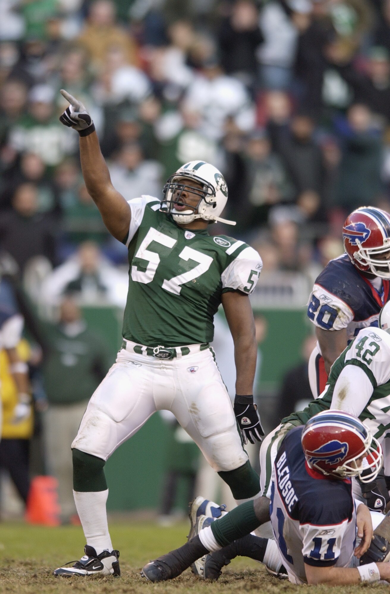 EAST RUTHERFORD, NJ - NOVEMBER 24:  Mo Lewis #57 of the New York Jets celebrates after Drew Bledsoe #11 of the Buffalo Bills was sacked during the NFL game on November 24, 2002 at Giant Stadium in East Rutherford, New Jersey. The Jets defeated the Bills 3