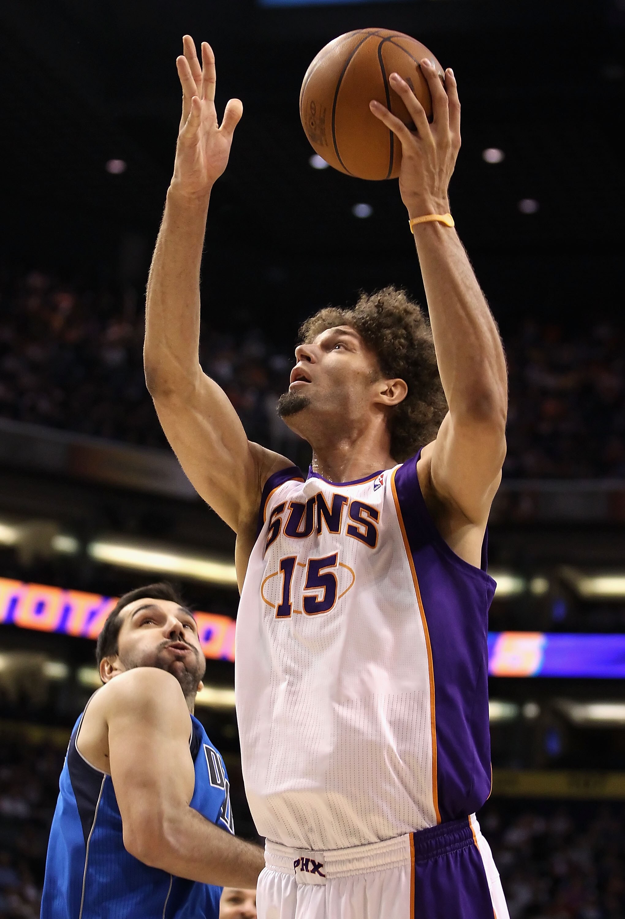 PHOENIX, AZ - FEBRUARY 17: Robin Lopez #15 of the Phoenix Suns puts up a shot past Peja Stojakovic #16 of the Dallas Mavericks during the NBA game at US Airways Center on February 17, 2011 in Phoenix, Arizona. NOTE TO USER: User expressly acknowledges a PHOENIX, AZ - FEBRUARY 17: Robin Lopez #15 of the Phoenix Suns puts up a shot past Peja Stojakovic #16 of the Dallas Mavericks during the NBA game at US Airways Center on February 17, 2011 in Phoenix, Arizona. NOTE TO USER: User expressly acknowledges a