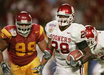 MIAMI - JANUARY 4: Running back Adrian Peterson #28 of the Oklahoma Sooners runs upfield against defensive tackle Mike Patterson #99 of the USC Trojans in the 2005 FedEx Orange Bowl National Championship on January 4, 2005 at Pro Player Stadium in Miami, MIAMI - JANUARY 4: Running back Adrian Peterson #28 of the Oklahoma Sooners runs upfield against defensive tackle Mike Patterson #99 of the USC Trojans in the 2005 FedEx Orange Bowl National Championship on January 4, 2005 at Pro Player Stadium in Miami,