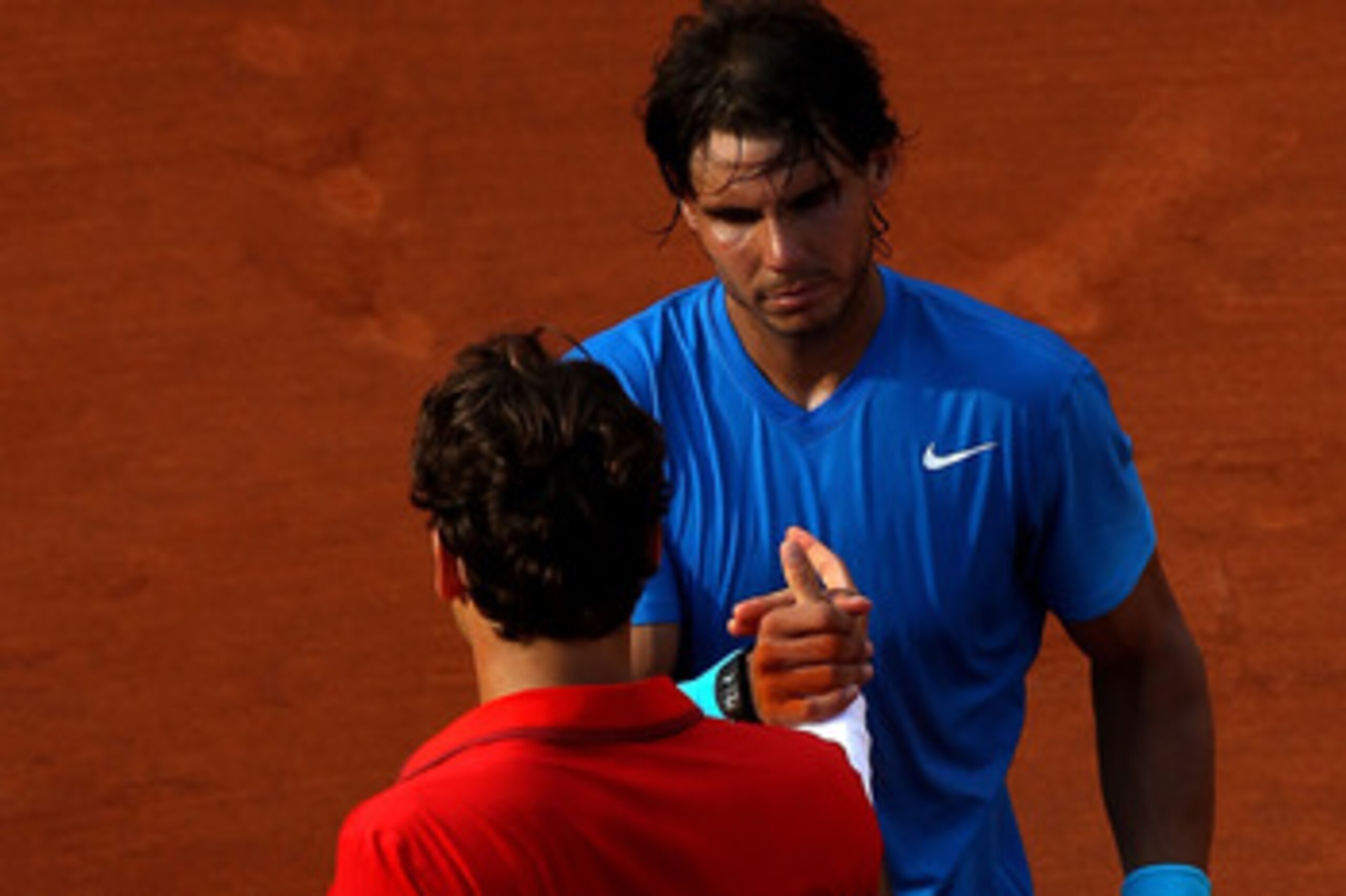 PARIS, FRANCE - JUNE 05:  Rafael Nadal of Spain shakes hands with Roger Federer of Switzerland following his victory during the men's singles final match between Rafael Nadal of Spain and Roger Federer of Switzerland on day fifteen of the French Open at R