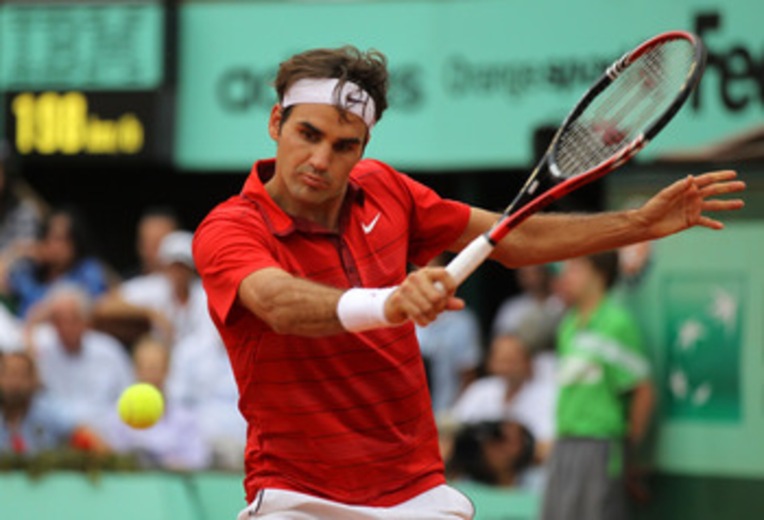 PARIS, FRANCE - JUNE 03:  Roger Federer of Switzerland hits a backhand during the men's singles semi final match between Roger Federer of Switzerland and Novak Djokovic of Serbia on day thirteen of the French Open at Roland Garros on June 3, 2011 in Paris