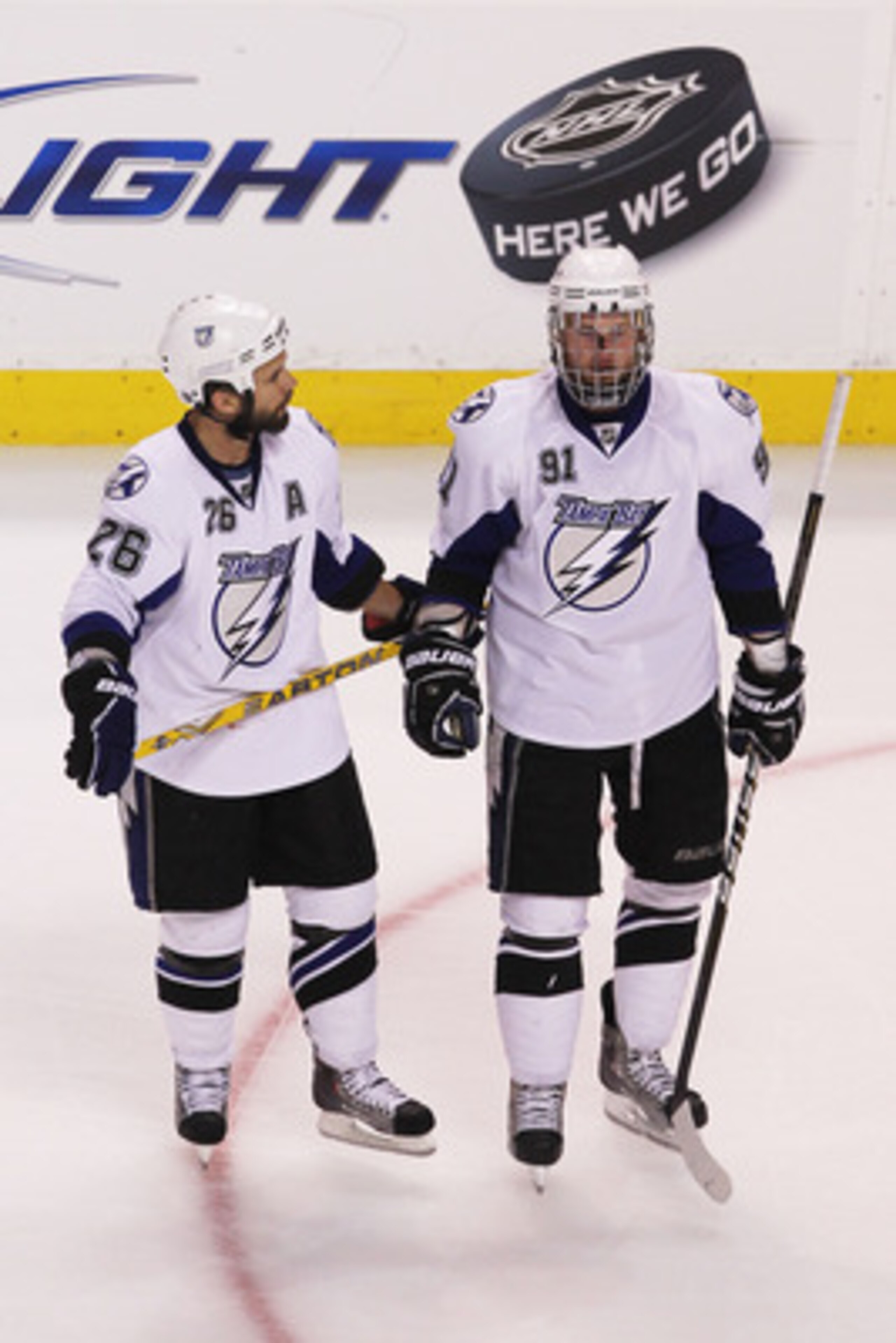 BOSTON, MA - MAY 27:  Martin St. Louis #26 talks to Steven Stamkos #91 of the Tampa Bay Lightning upon Stamkos' returned to the game after being hhit in the face with a puck in Game Seven of the Eastern Conference Finals against the Boston Bruins during t