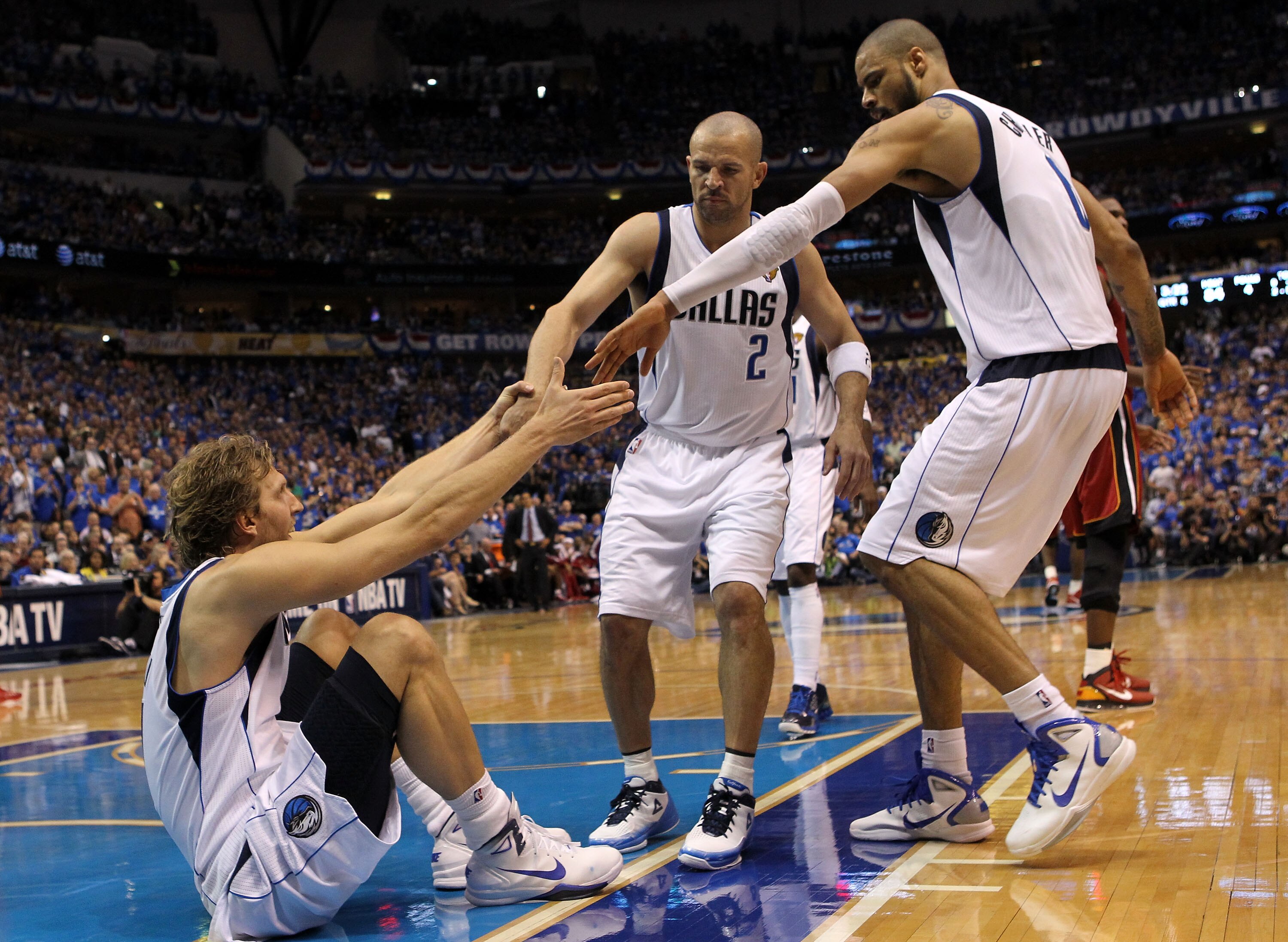 DALLAS, TX - JUNE 05:  Dirk Nowitzki #41 of the Dallas Mavericks is helped up by teammates Jason Kidd #2 and Tyson Chandler #6 while taking on the Miami Heat in Game Three of the 2011 NBA Finals at American Airlines Center on June 5, 2011 in Dallas, Texas