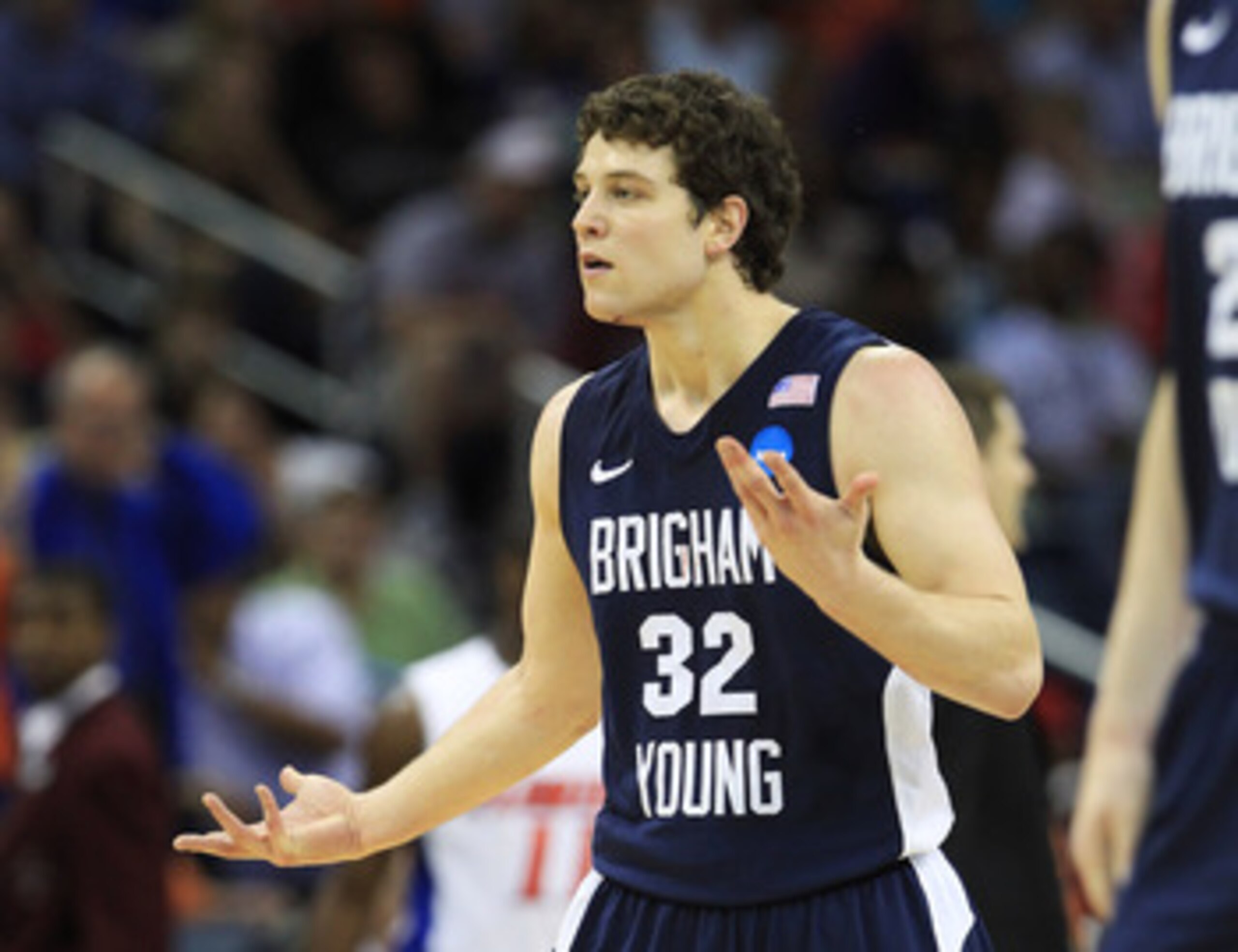 NEW ORLEANS, LA - MARCH 24:  Jimmer Fredette #32 of the Brigham Young Cougars reacts after being injured during their game against the Florida Gators in the Southeast regional of the 2011 NCAA men's basketball tournament at New Orleans Arena on March 24, 