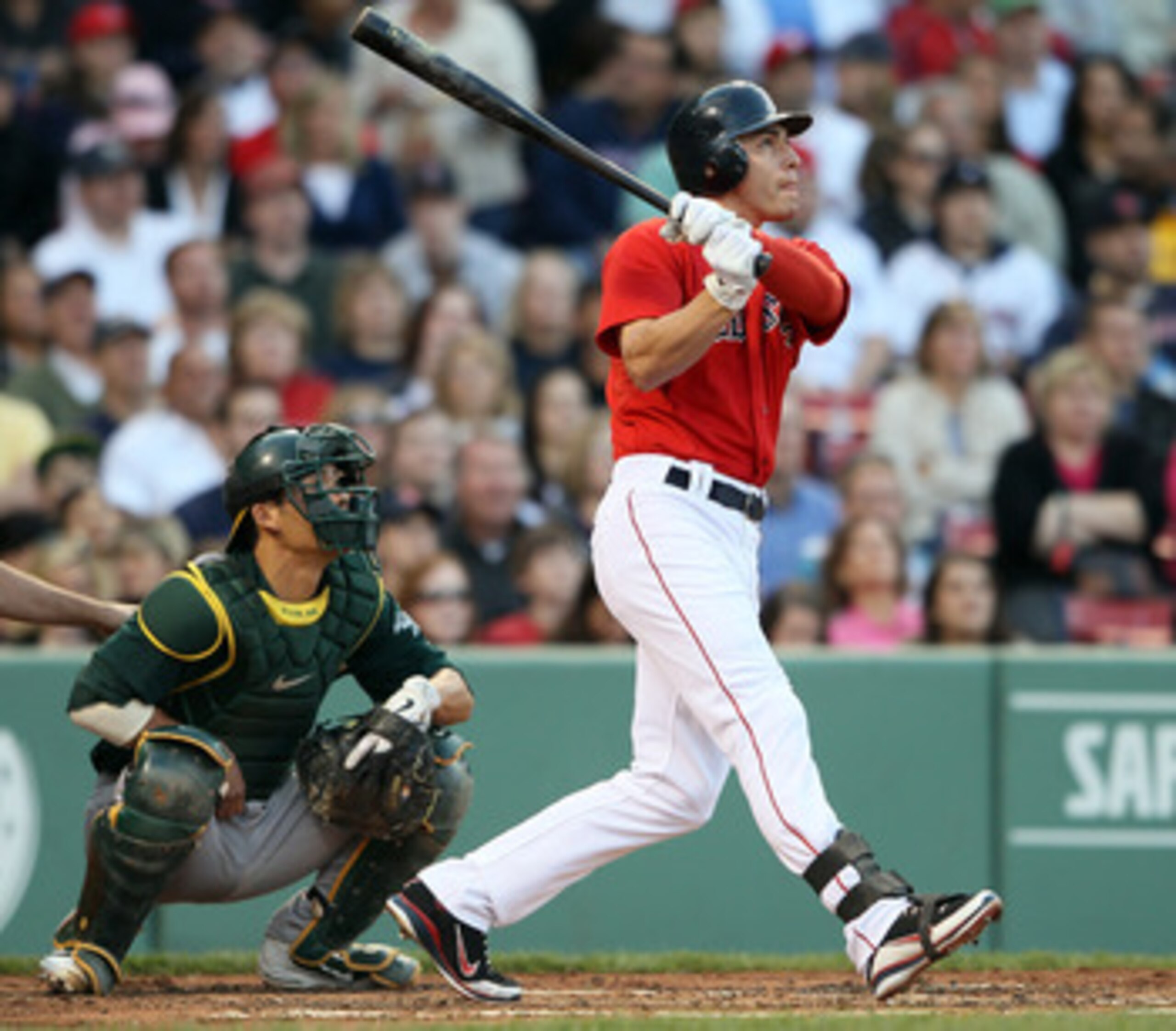 BOSTON, MA - JUNE 03: Jacoby Ellsbury #2 of the Boston Red Sox gets a hit in the first inning as Kurt Suzuki #8 of the Oakland Athletics defends on June 3, 2011 at Fenway Park in Boston, Massachusetts.  (Photo by Elsa/Getty Images)