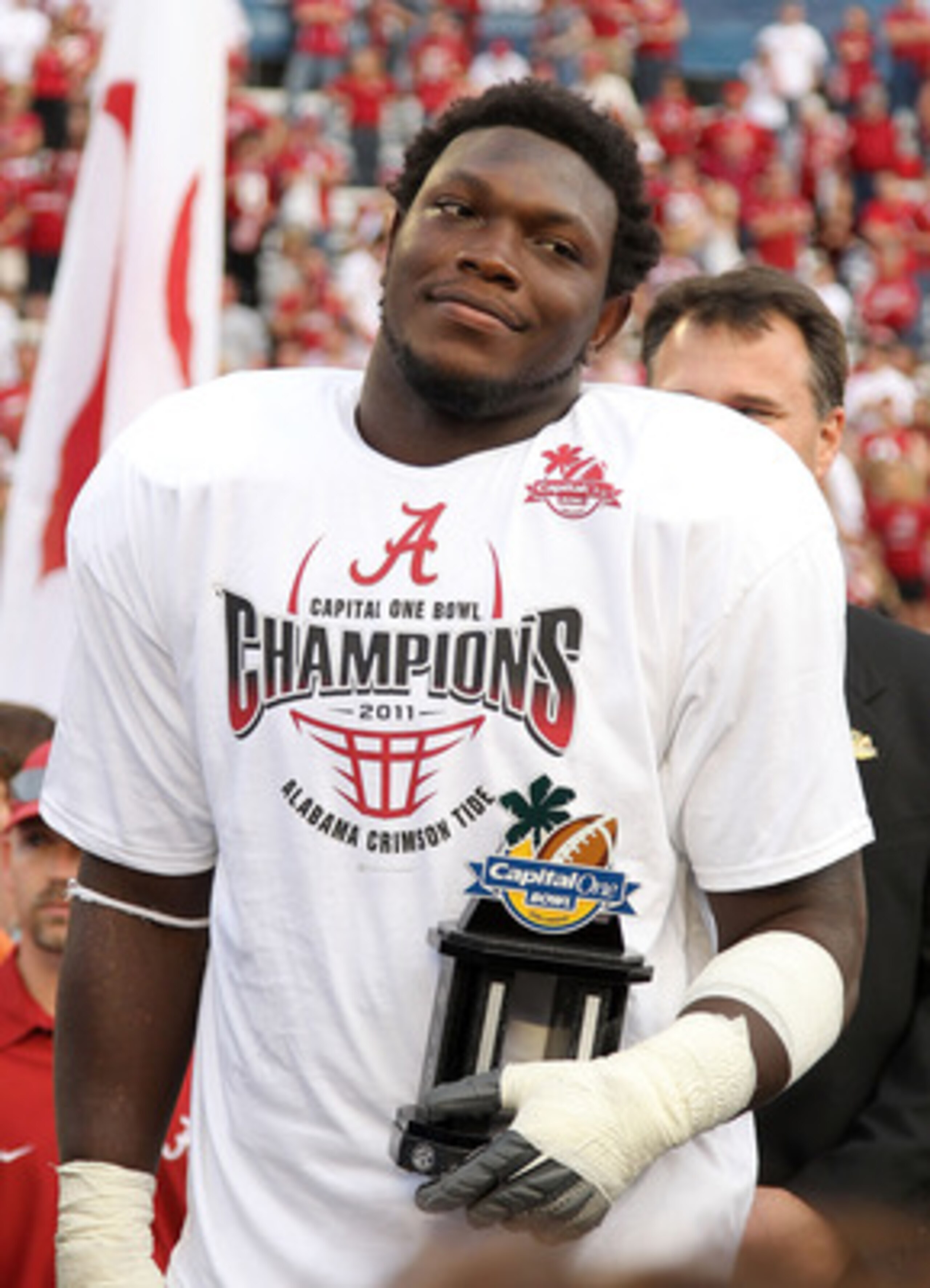 ORLANDO, FL - JANUARY 01:  Courtney Upshaw #41 of the Alabama Crimson Tide accepts the MVP award after winning the Capitol One Bowl against the Michigan State Spartans at the Florida Citrus Bowl on January 1, 2011 in Orlando, Florida.  (Photo by Mike Ehrm