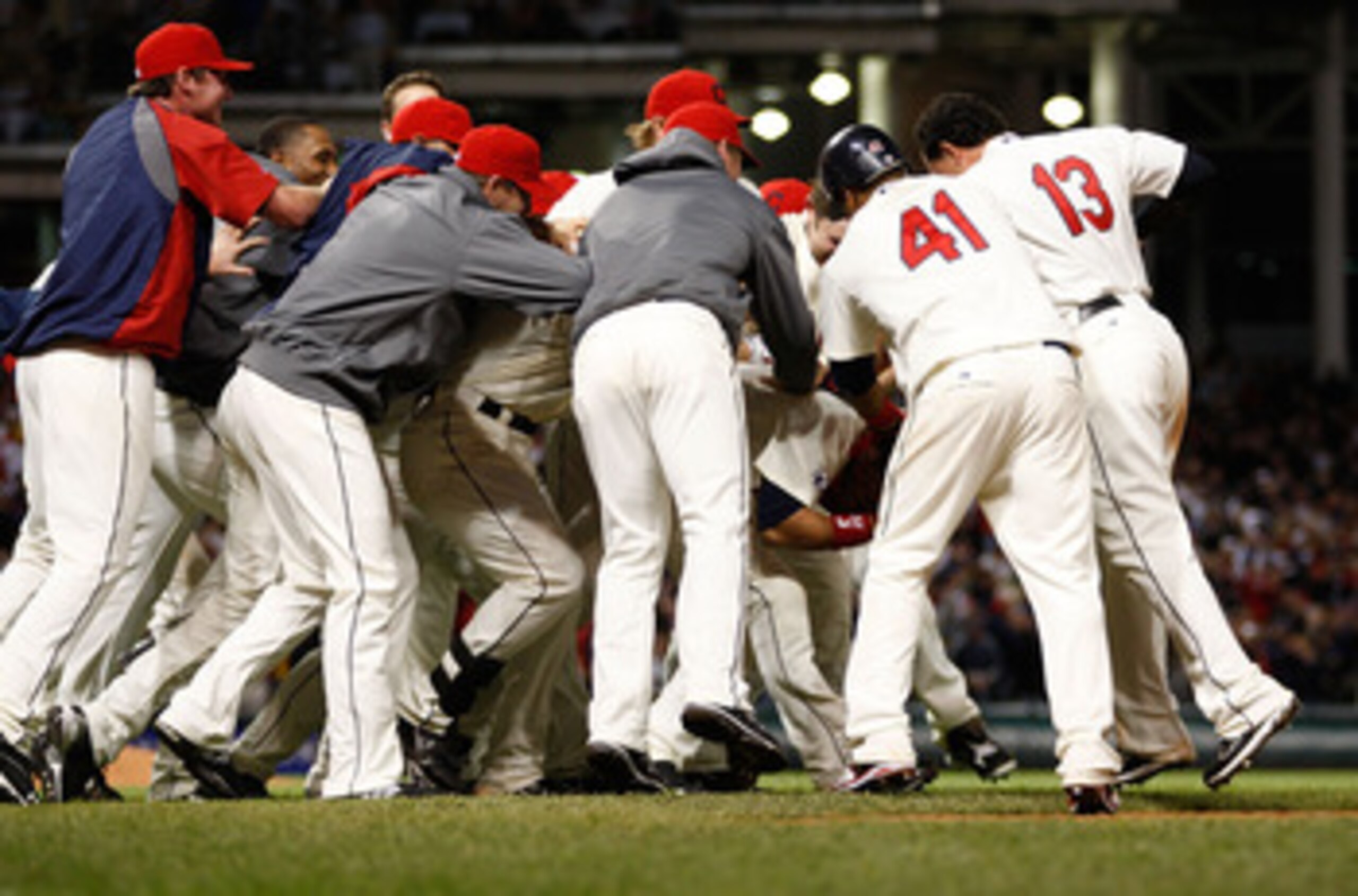 CLEVELAND - APRIL 30:  Members of the Cleveland Indians mob their teammate Orlando Cabrera #20 after he hit a walk-off game winning single in the 13th inning against the Detroit Tigers during the game on April 30, 2011 at Progressive Field in Cleveland, O
