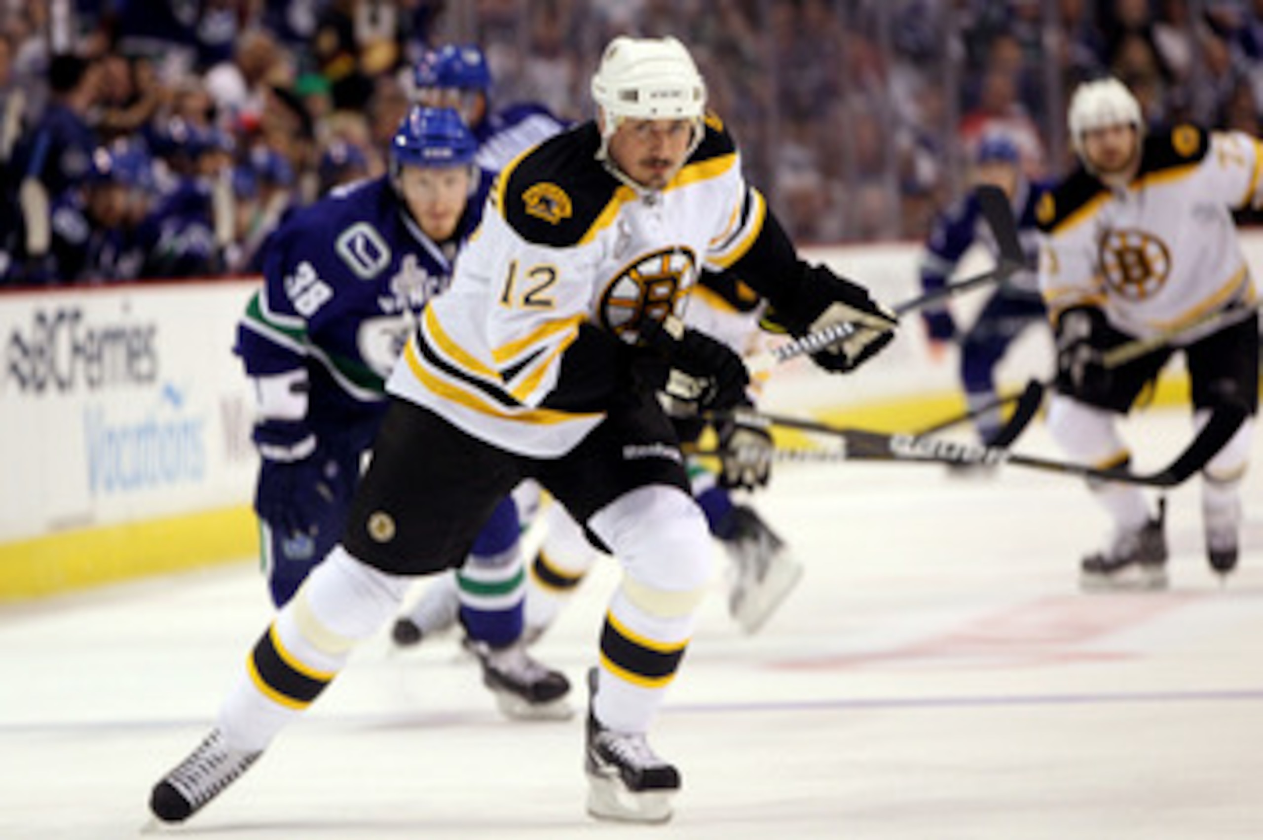 VANCOUVER, BC - JUNE 04:  Tomas Kaberle #12 of the Boston Bruins skates against Victor Oreskovich #38 of the Vancouver Canucks during Game Two of the 2011 NHL Stanley Cup Final at Rogers Arena on June 4, 2011 in Vancouver, British Columbia, Canada.  (Phot