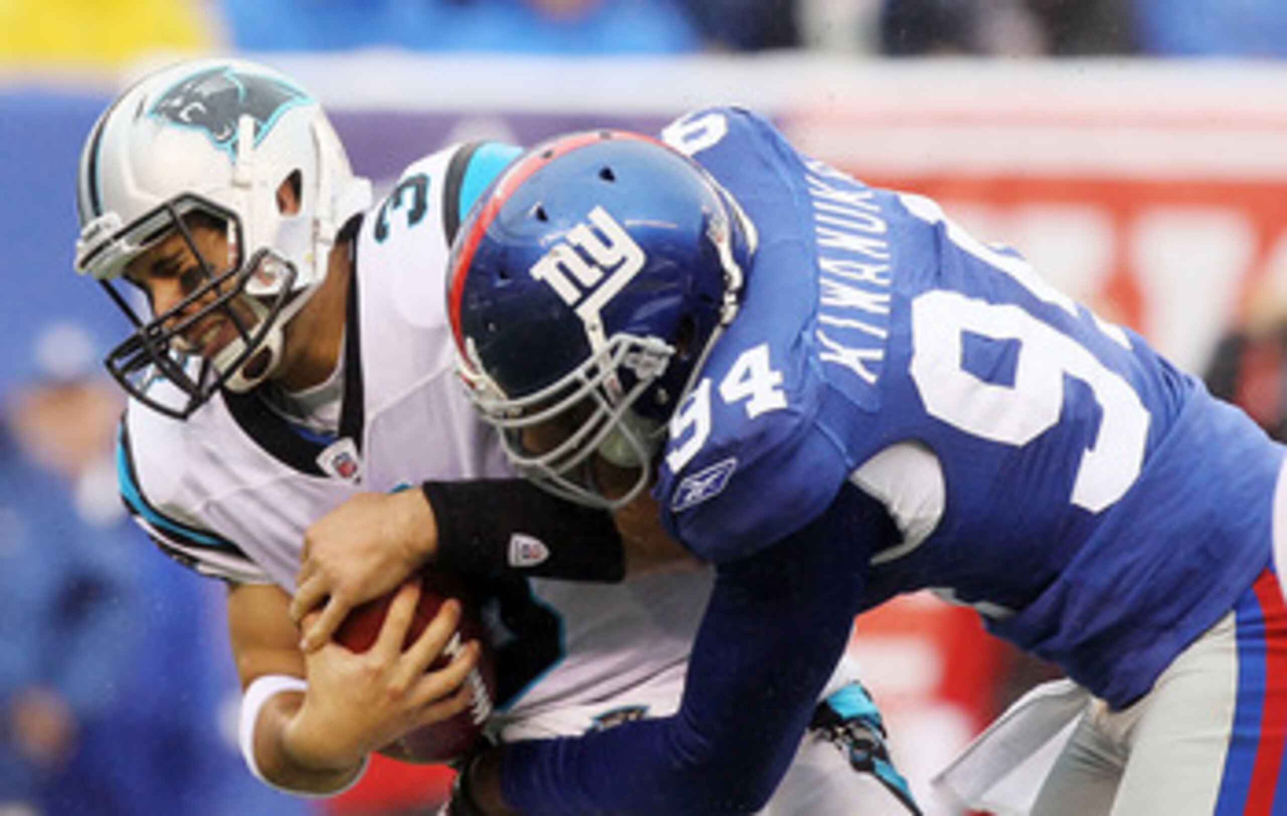 EAST RUTHERFORD, NJ - SEPTEMBER 12:  Matt Moore #3 of the Carolina Panthers is sacked in the fourth quarter by Mathias Kiwanuka #94 of the New York Giants on September 12, 2010 at the New Meadowlands Stadium in East Rutherford, New Jersey. The Giants defe