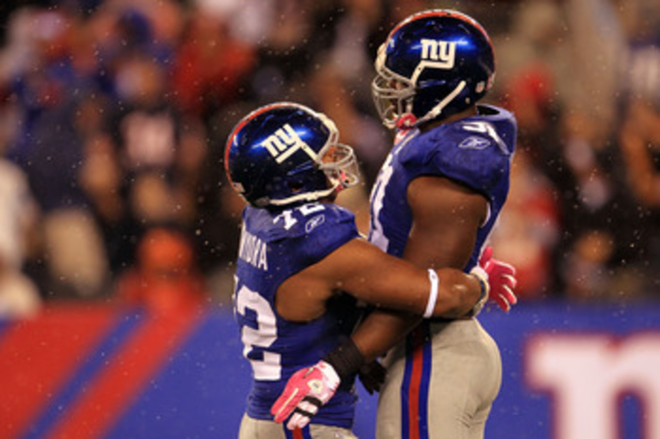 EAST RUTHERFORD, NJ - OCTOBER 03:  Osi Umenyiora #72 and Justin Tuck #91 of the New York Giants celebrates after a sack against the Chicago Bear at New Meadowlands Stadium on October 3, 2010 in East Rutherford, New Jersey.  (Photo by Chris McGrath/Getty I