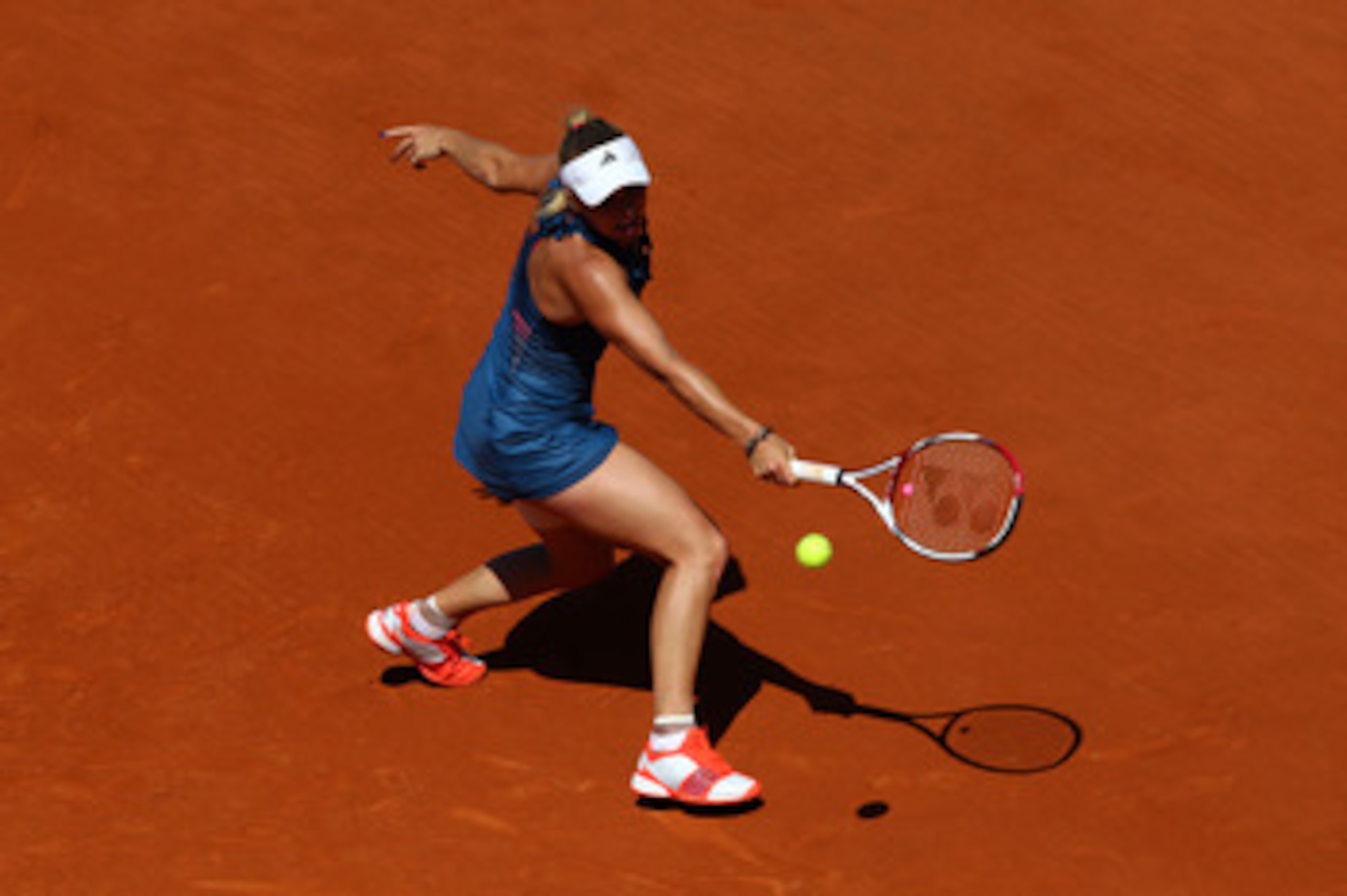 PARIS, FRANCE - MAY 25:  Caroline Wozniacki of Denmark hits a backhand during the women's singles round two match between Caroline Wozniacki of Denmark and Aleksandra Wozniak of Canada on day four of the French Open at Roland Garros on May 25, 2011 in Par