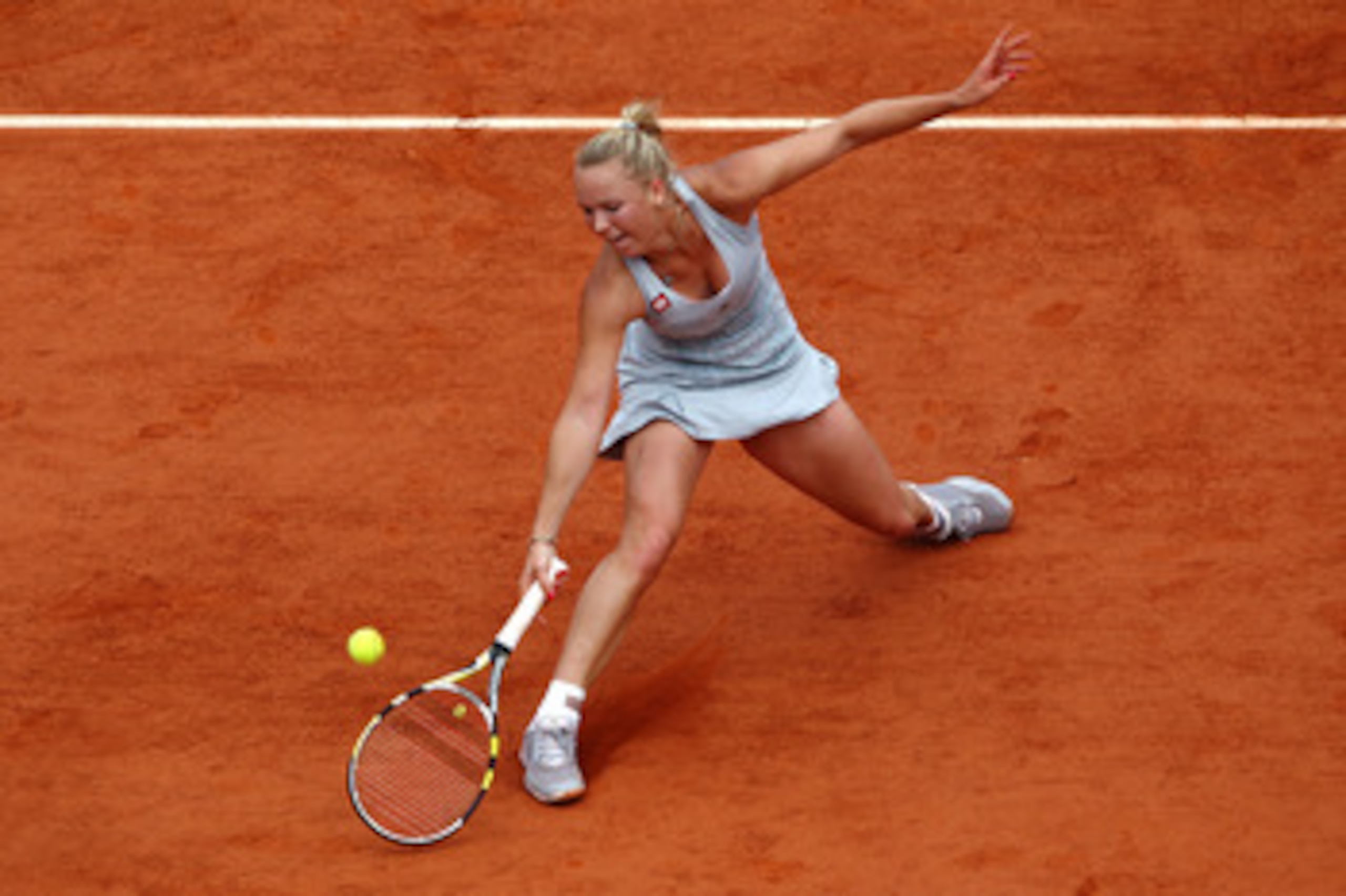 PARIS - MAY 30:  Caroline Wozniacki of Denmark plays a forehand volley during the women's singles fourth round match between Caroline Wozniacki of Denmark and Flavia Pennetta of Italy on day eight of the French Open at Roland Garros on May 30, 2010 in Par