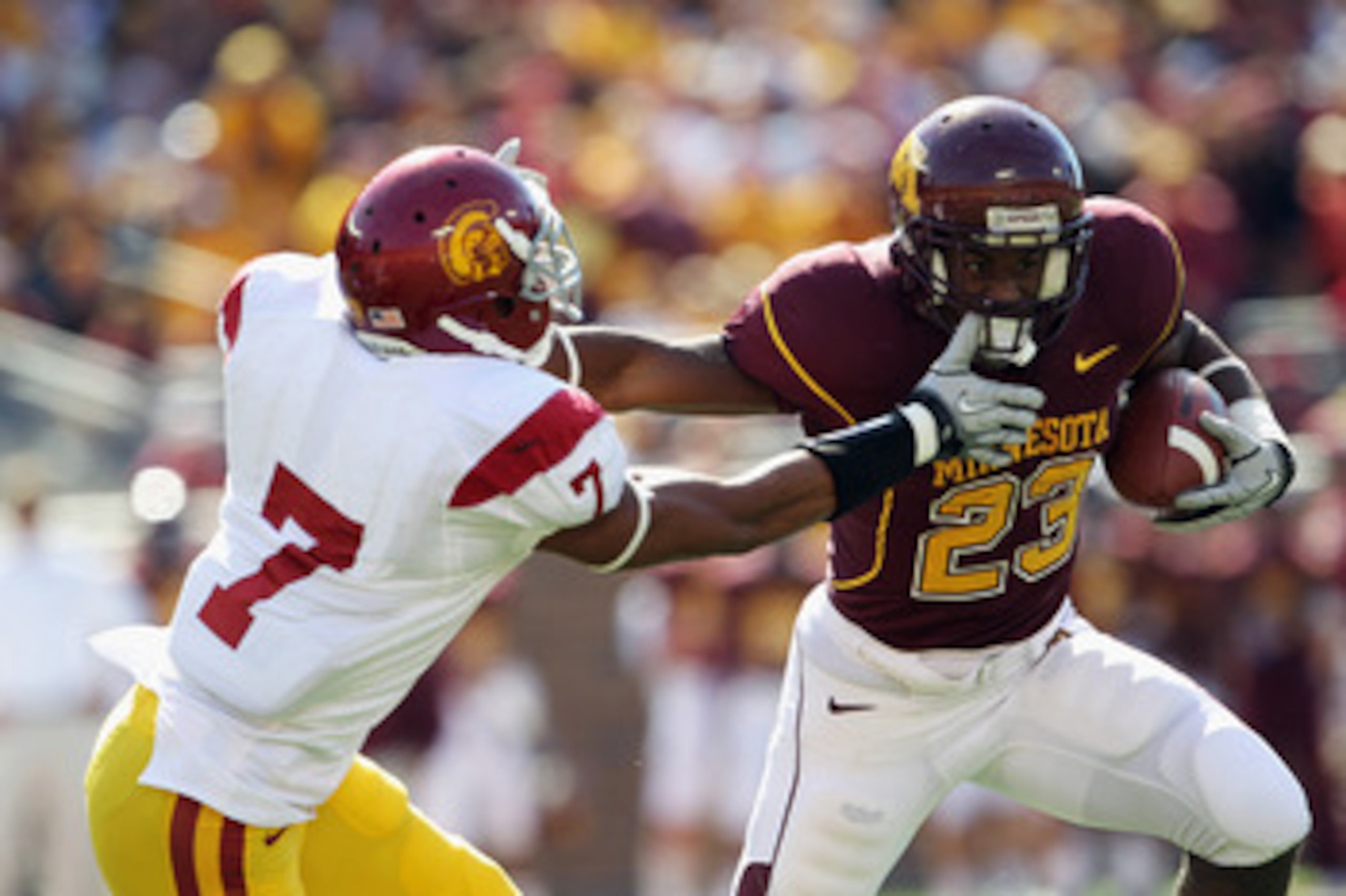 MINNEAPOLIS - SEPTEMBER 18:  Eskridge DeLeon #23 of the Minnesota Golden Gophers carries the ball as T.J. McDonald #7 of the USC Trojans defends during the game on September 18, 2010 at TCF Bank Stadium in Minneapolis, Minnesota.  (Photo by Jamie Squire/G