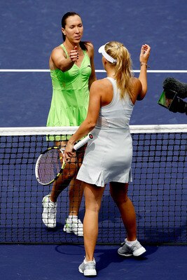 INDIAN WELLS, CA - MARCH 21:  Jelena Jankovic (L) of Serbia is congratulated at the net by Caroline Wozniacki of Denmark during the final of the BNP Paribas Open on March 21, 2010 at the Indian Wells Tennis Garden in Indian Wells, California.  (Photo by M