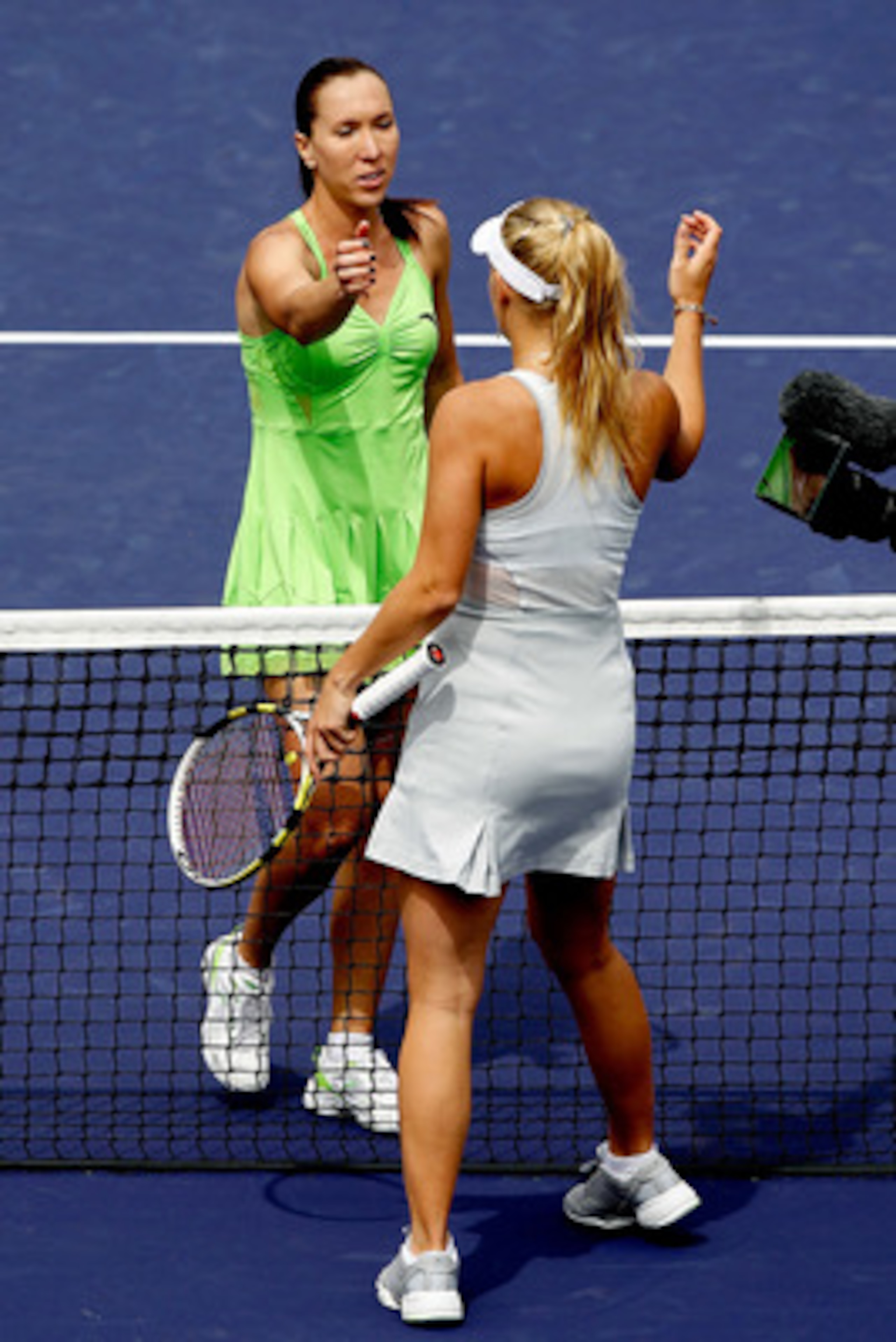 INDIAN WELLS, CA - MARCH 21:  Jelena Jankovic (L) of Serbia is congratulated at the net by Caroline Wozniacki of Denmark during the final of the BNP Paribas Open on March 21, 2010 at the Indian Wells Tennis Garden in Indian Wells, California.  (Photo by M