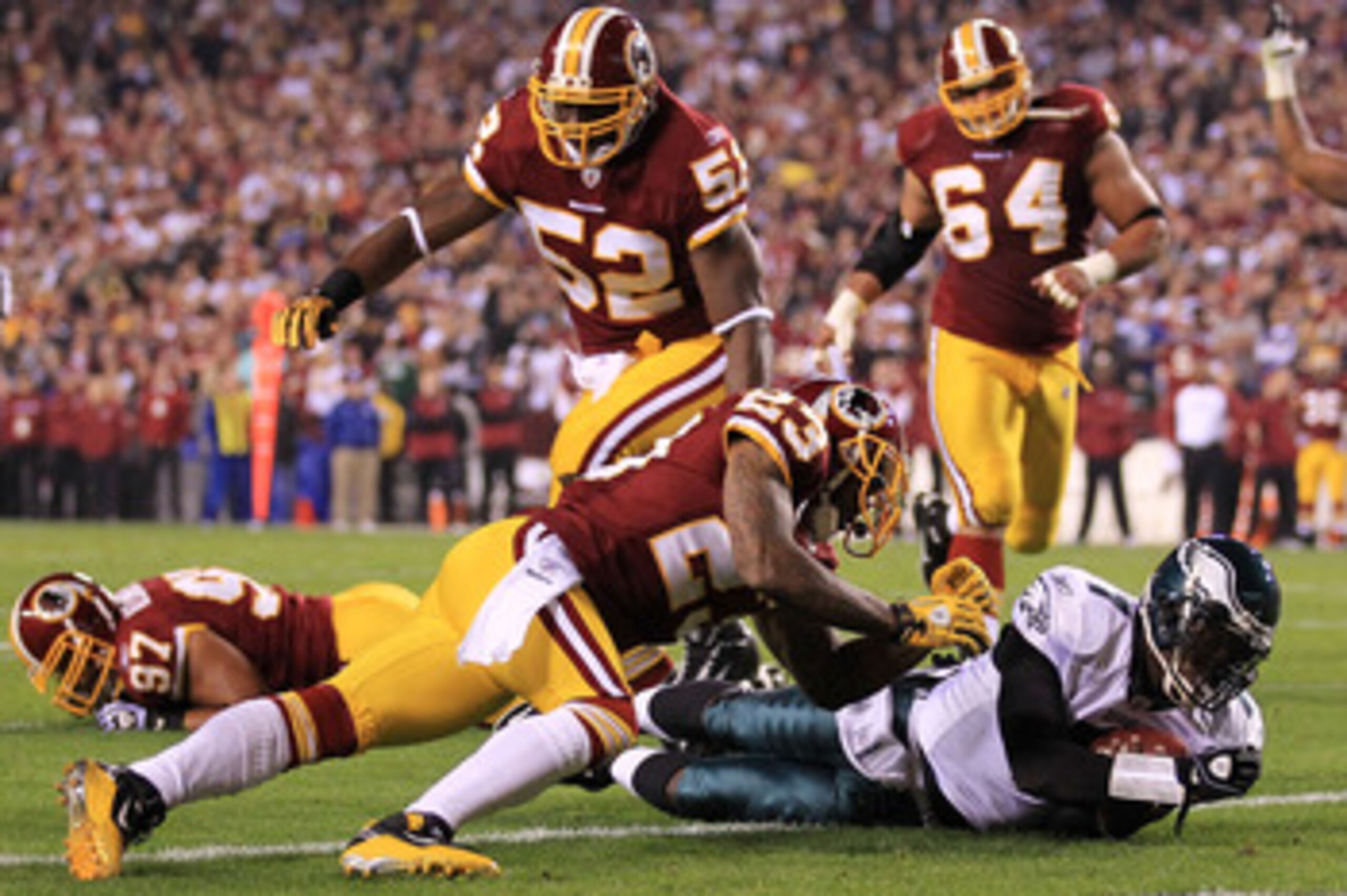 LANDOVER, MD - NOVEMBER 15:  Michael Vick #7 of the Philadelphia Eagles dives over to score a touchdown against the Washington Redskins on November 15, 2010 at FedExField in Landover, Maryland.  (Photo by Chris McGrath/Getty Images)