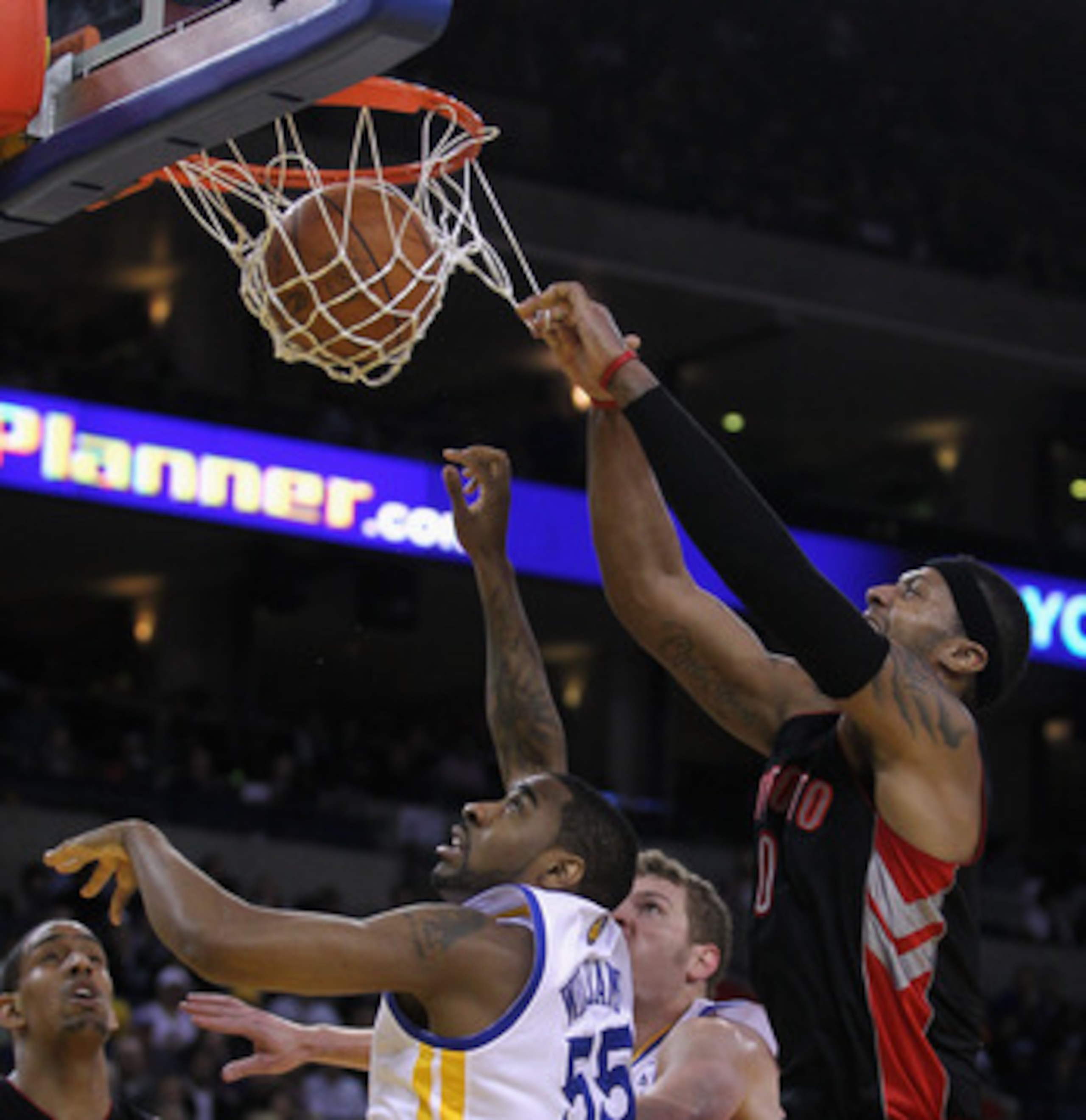OAKLAND, CA - MARCH 25: James Johnson #0 of the Toronto Raptors shoots over Reggie Williams #55 of the Golden State Warriors at Oracle Arena on March 25, 2011 in Oakland, California. NOTE TO USER: User expressly acknowledges and agrees that, by downloadin