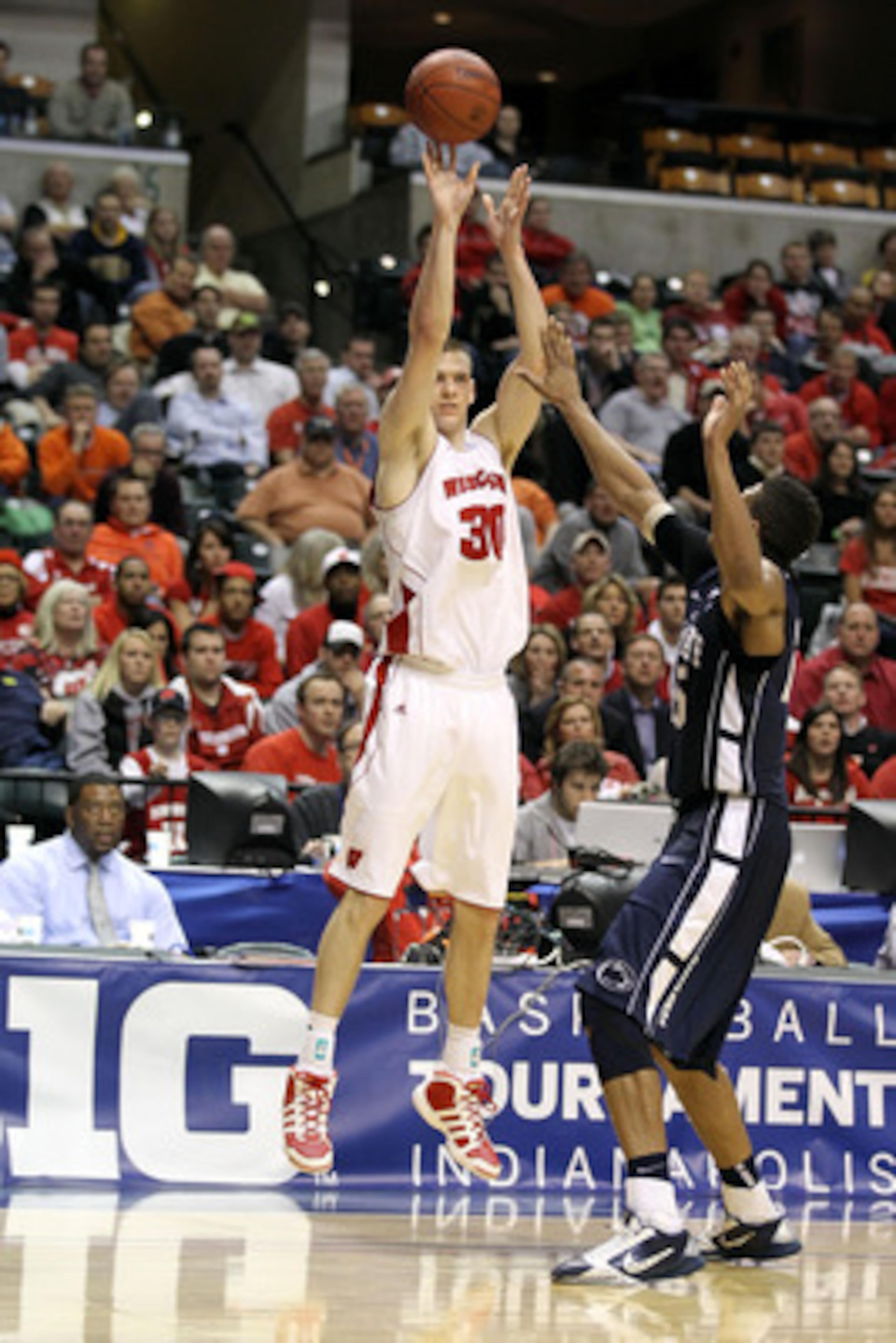 INDIANAPOLIS, IN - MARCH 11:  Jon Leuer #30 of the Wisconsin Badgers attempts a shot against the Penn State Nittany Lions during the quarterfinals of the 2011 Big Ten Men's Basketball Tournament at Conseco Fieldhouse on March 11, 2011 in Indianapolis, Ind