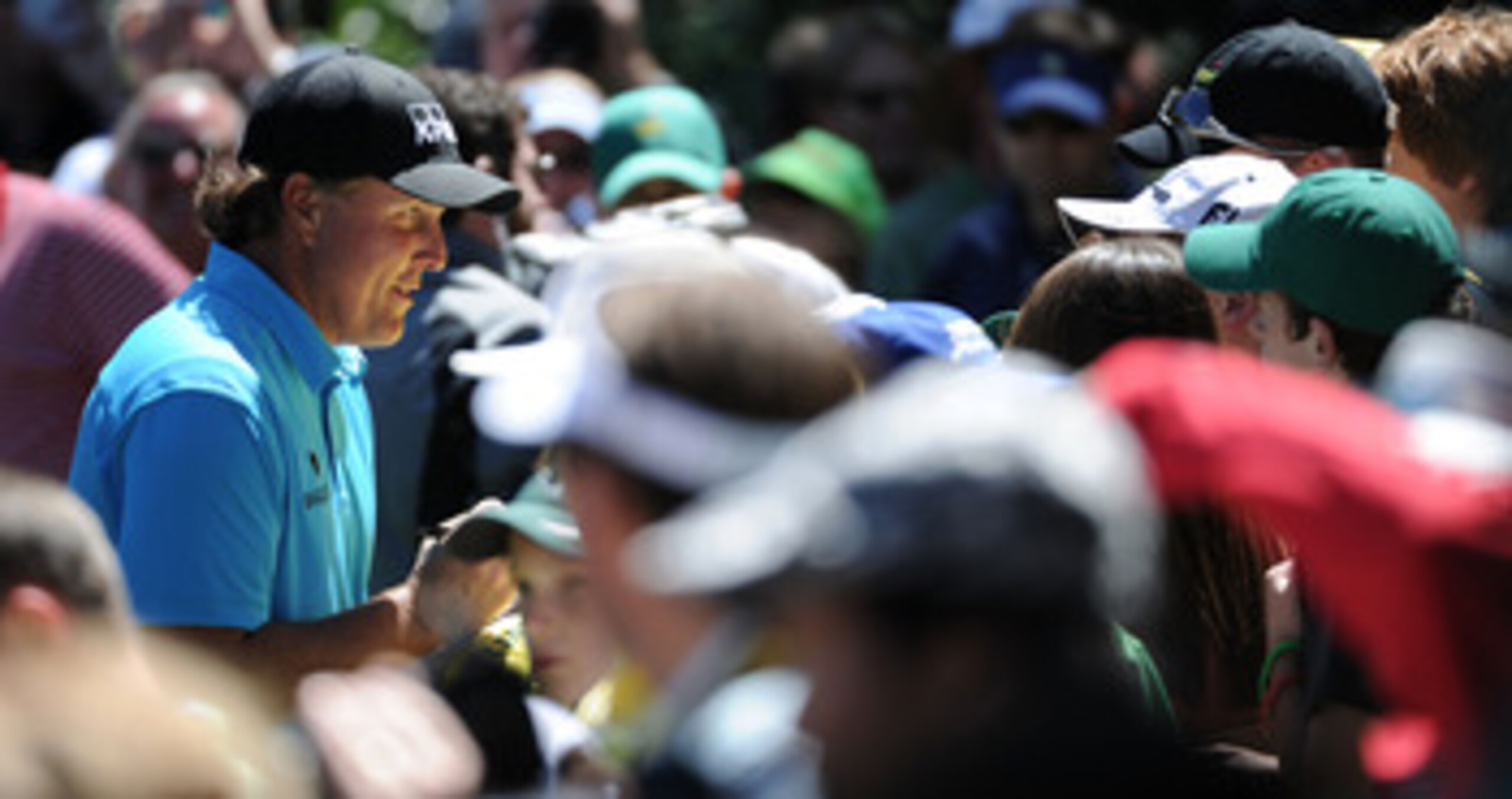 AUGUSTA, GA - APRIL 06:  Phil Mickelson signs autographs for fans during the Par 3 Contest prior to the 2011 Masters Tournament at Augusta National Golf Club on April 6, 2011 in Augusta, Georgia.  (Photo by Harry How/Getty Images)