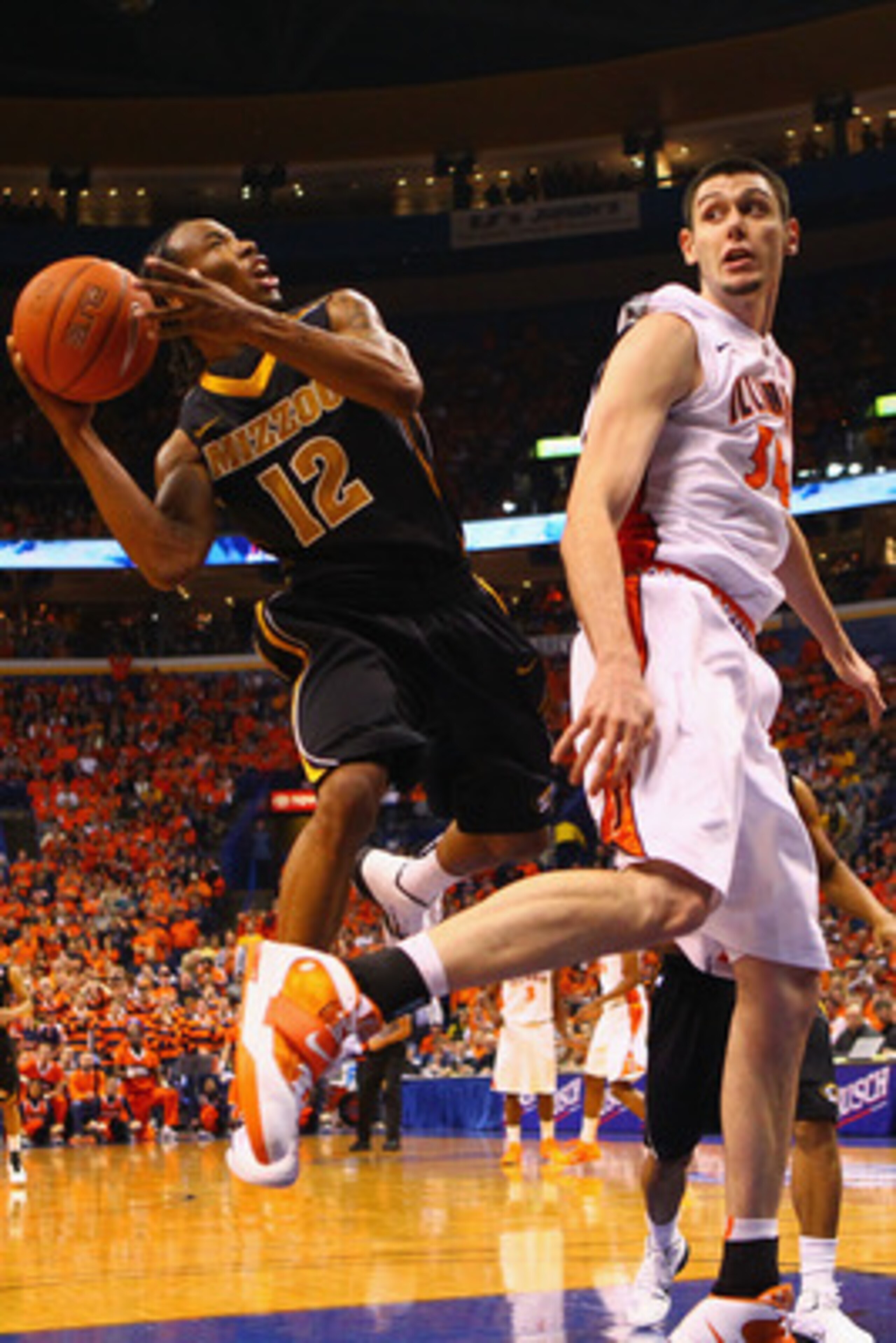 ST. LOUIS, MO - DECEMBER 22: Marcus Denmon #12 of the Missouri Tigers shoots the ball against Mike Tisdale #54 of the Illinois Fighting Illini during the Busch Braggin' Rights game at the Scottrade Center on December 22, 2010 in St. Louis, Missouri.  The