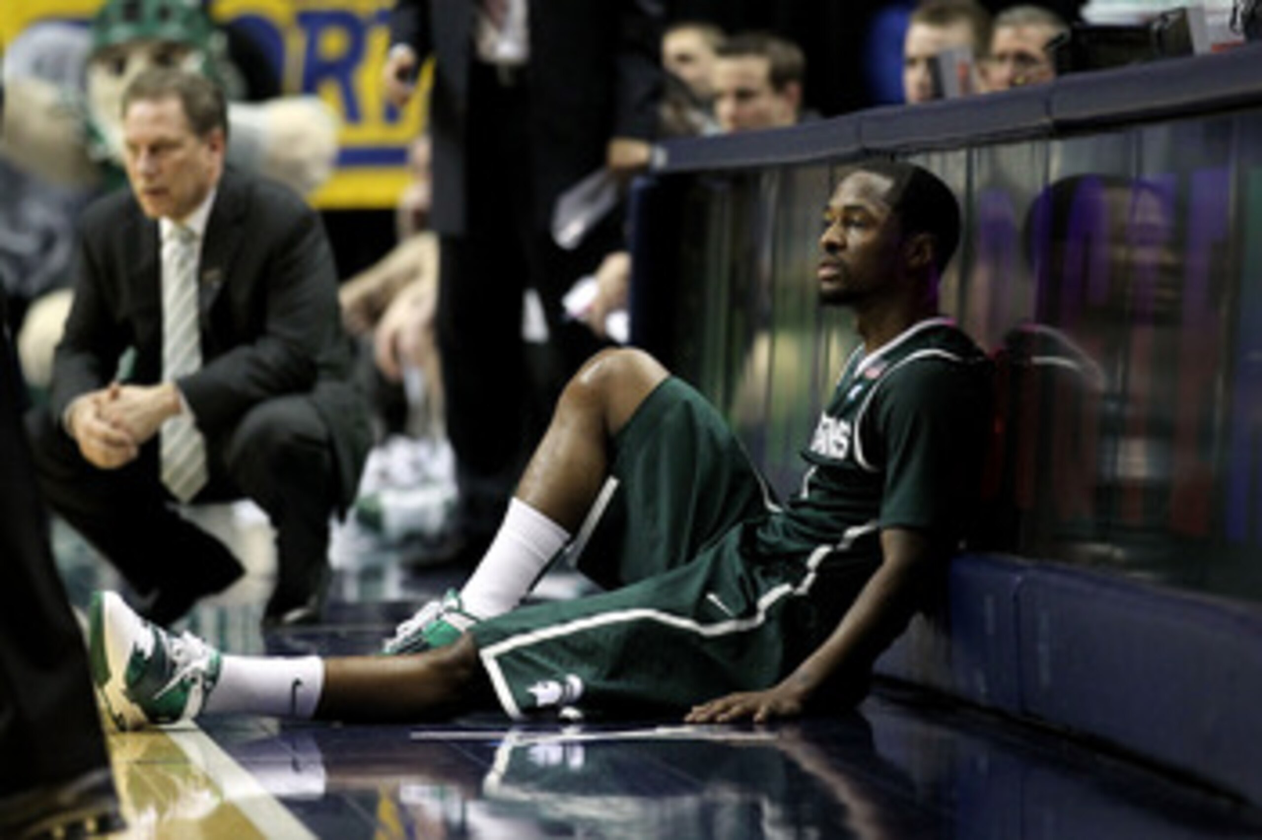 INDIANAPOLIS, IN - MARCH 12:  Kalin Lucas #1 of the Michigan State Spartans sits next to the scorer's table against the Penn State Nittany Lions during the semifinals of the 2011 Big Ten Men's Basketball Tournament at Conseco Fieldhouse on March 12, 2011