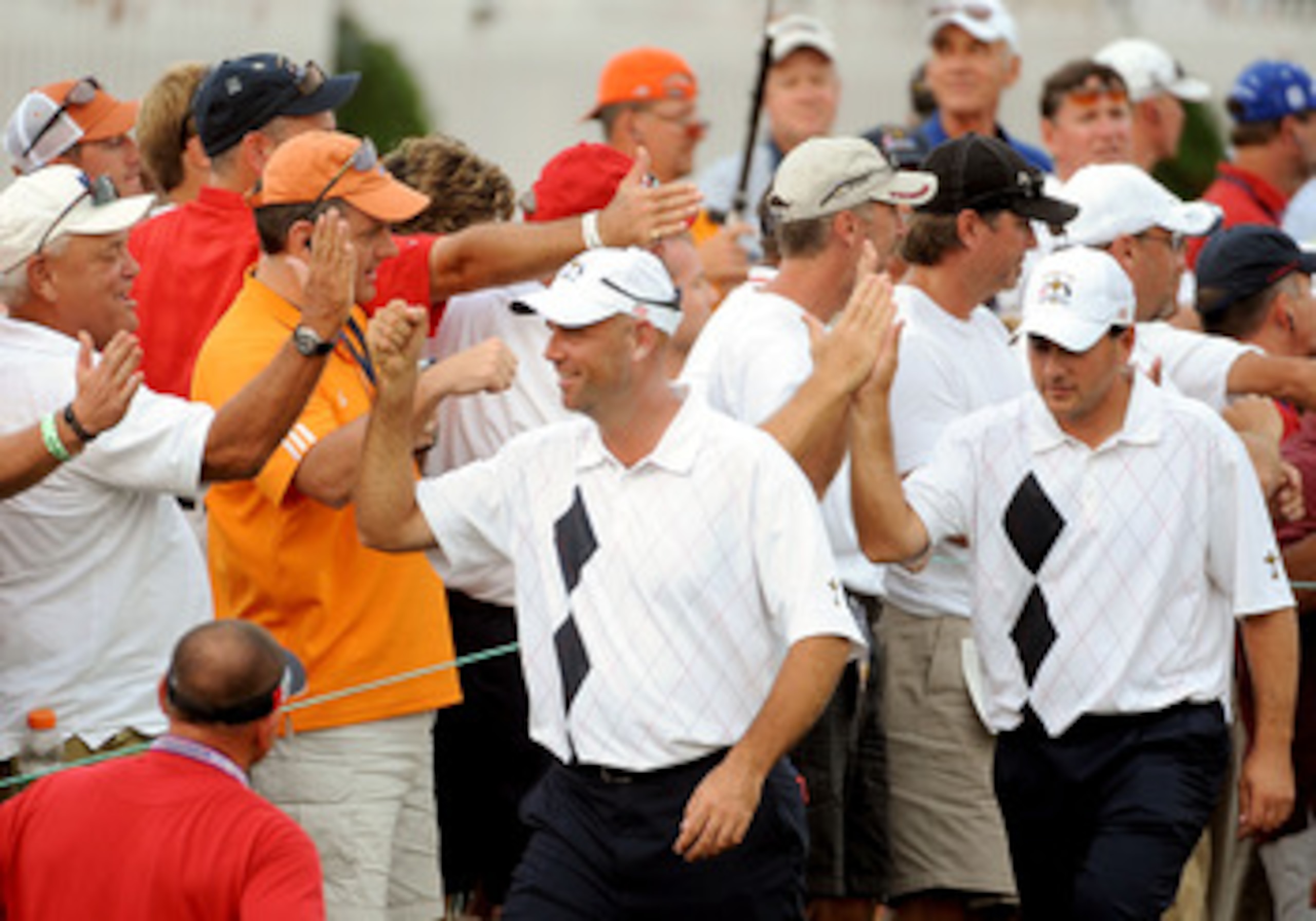 LOUISVILLE, KY - SEPTEMBER 19: Stewart Cink and Ben Curtis of the USA team celebrates with fans on the 17th hole during the afternoon four-ball matches on day one of the 2008 Ryder Cup at Valhalla Golf Club on September 19, 2008 in Louisville, Kentucky.  