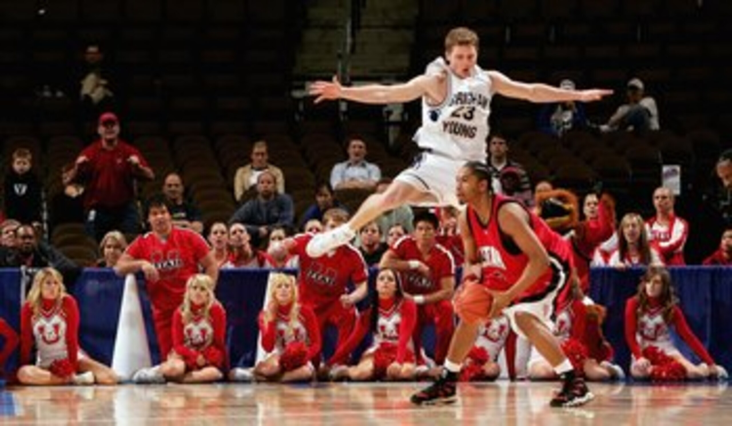 DENVER - MARCH 09:  Jimmy Balderson #23 of the Brigham Young University Cougars defends as Lawrence Bryant #2 of the Utah Runnin' Utes looks for an open teammate as the Utes upset the Cougars 74-70 during the Mountain West Conference Basketball Tournament
