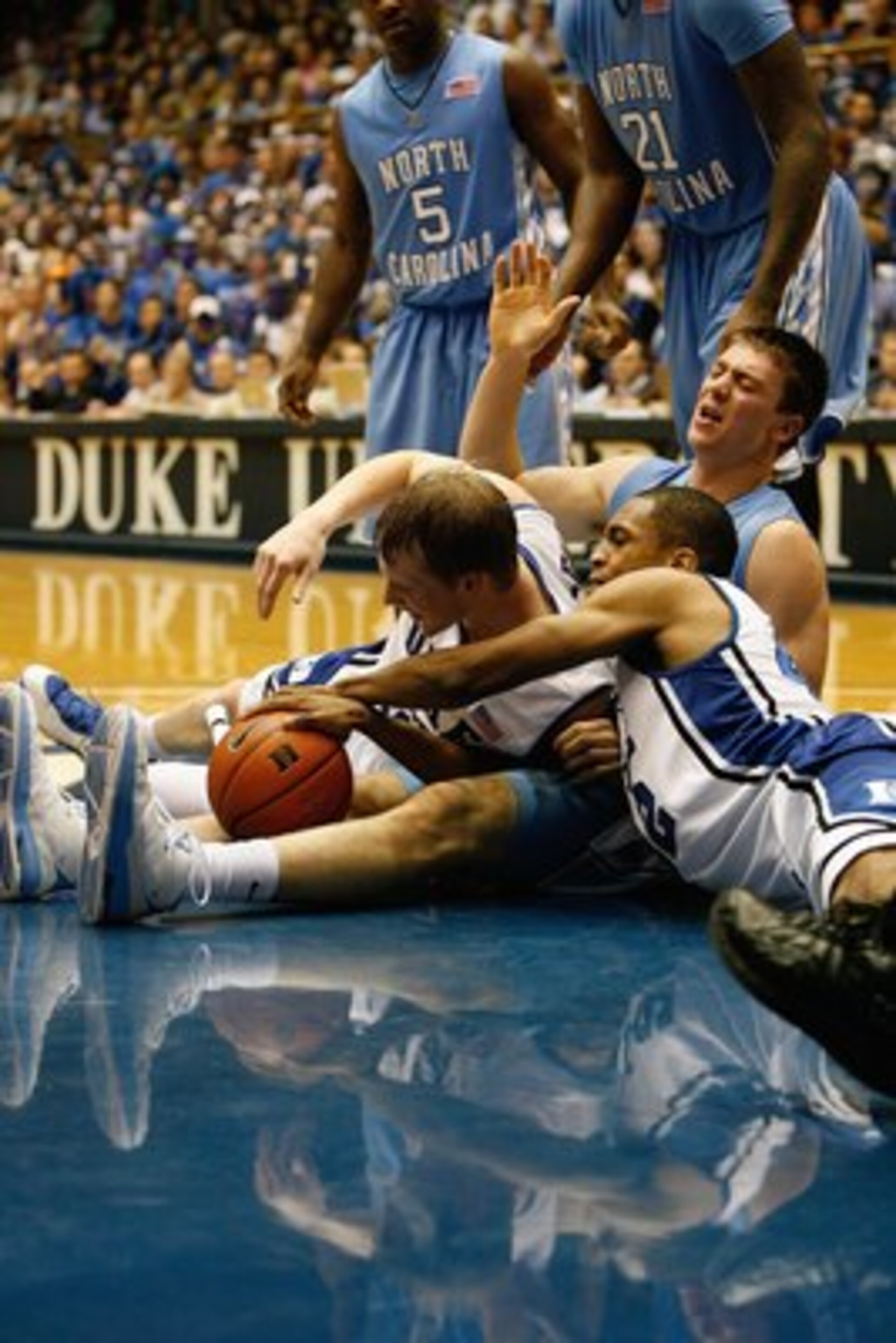 DURHAM, NC - FEBRUARY 11:  Tyler Hansbrough #50 of the North Carolina Tar Heels reacts after being elbowed by Kyle Singler #12 of the Duke Blue Devils during the game on February 11, 2009 at Cameron Indoor Stadium in Durham, North Carolina.  (Photo by Kev