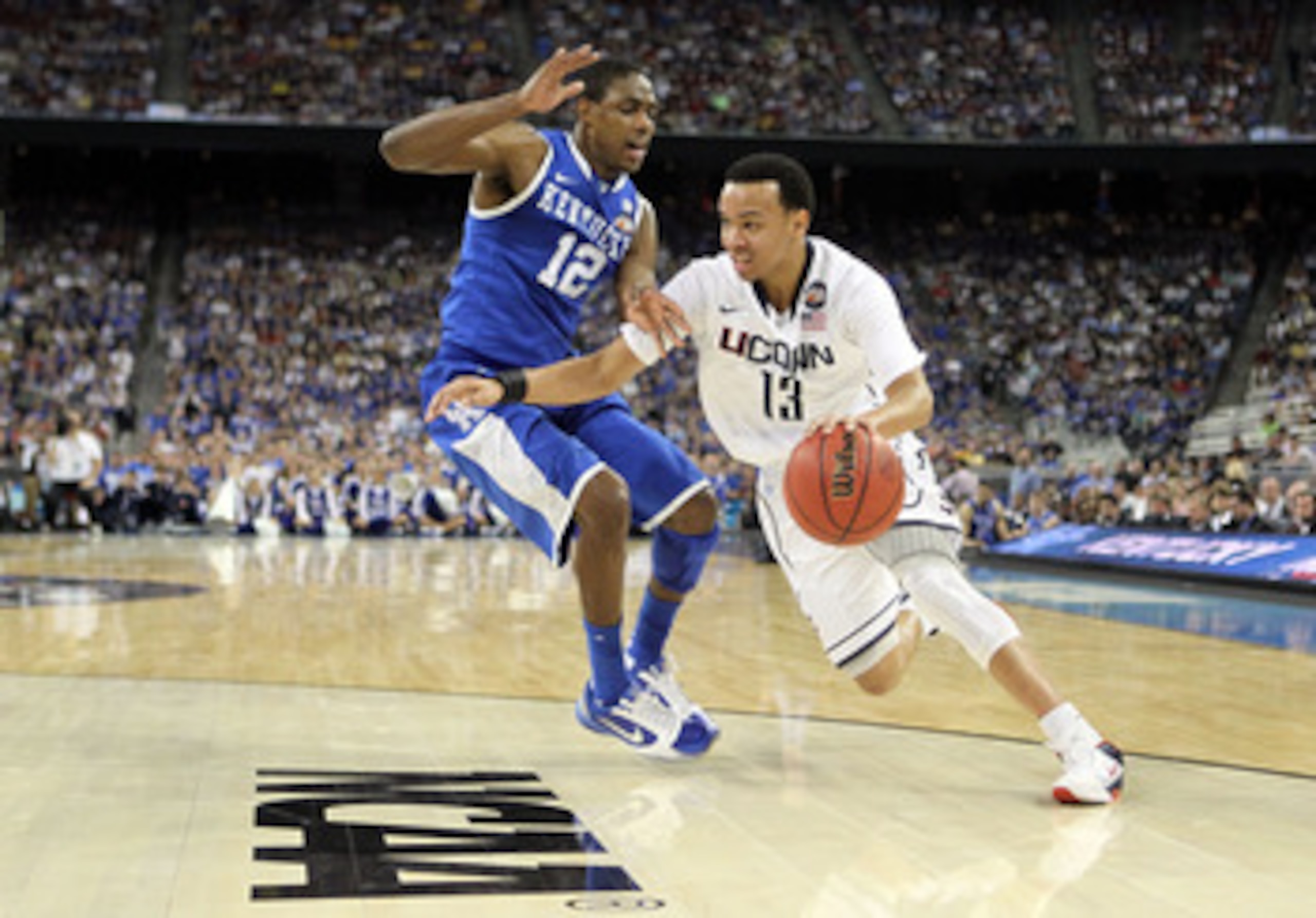 HOUSTON, TX - APRIL 02:  Shabazz Napier #13 of the Connecticut Huskies drives on Brandon Knight #12 of the Kentucky Wildcats during the National Semifinal game of the 2011 NCAA Division I Men's Basketball Championship at Reliant Stadium on April 2, 2011 i