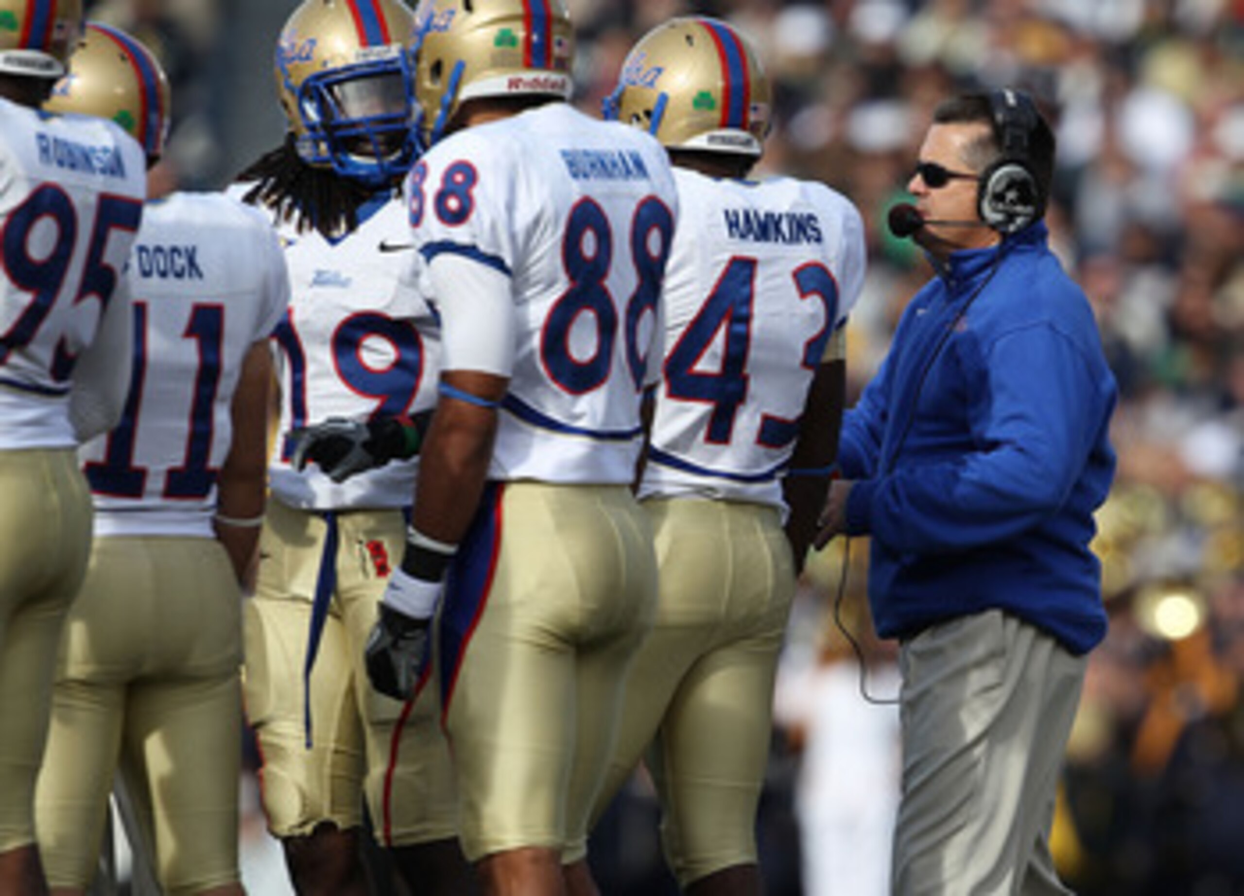 SOUTH BEND, IN - OCTOBER 30: Head coach Todd Graham of the Tulsa Golden Hurricane talks to his team including (L-R) Alan Dock #11, Milton Howell #19, Bryan Burnham #88 and Donnell Hawkins #43 during a game against the Notre Dame Fighting Irish at Notre Da