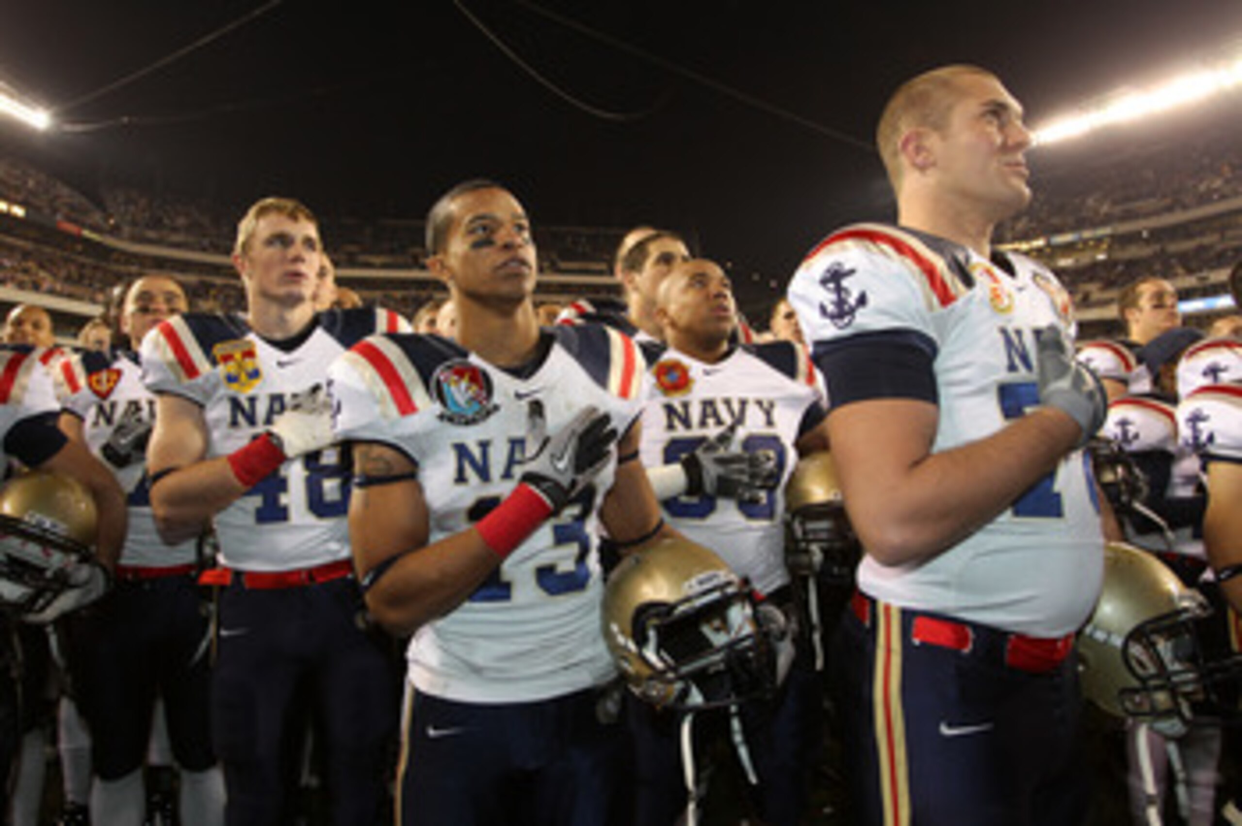 PHILADELPHIA - DECEMBER 11: Safety Jordan Fraser #13 of the Navy Midshipmen listens to the Navel Academy's alma mater with teammates after a game against the Army Black Knights on December 11, 2010 at Lincoln Financial Field in Philadelphia, Pennsylvania.