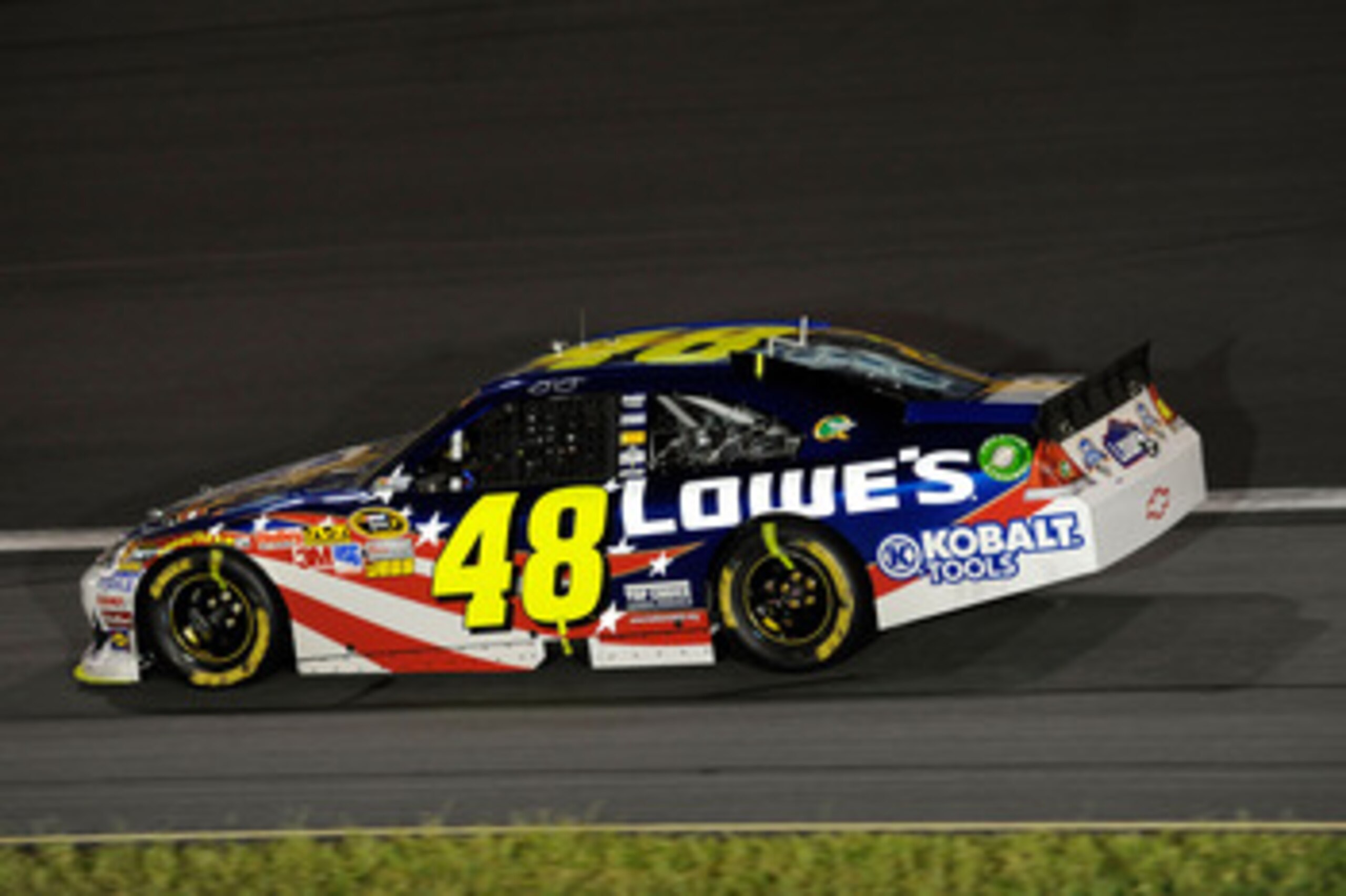 CONCORD, NC - MAY 29:  Jimmie Johnson drives the #48 Lowe's Summer Salute Chevrolet on the aprin after an incident in the NASCAR Sprint Cup Series Coca-Cola 600 at Charlotte Motor Speedway on May 29, 2011 in Concord, North Carolina.  (Photo by John Harrel