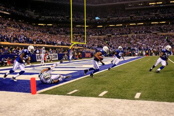 INDIANAPOLIS, IN - JANUARY 08:  Justin Tryon #20 of the Indianapolis Colts returns an interception for positive yards on a pass intended for Dustin Keller #81 of the New York Jets during the second quarter of their 2011 AFC wild card playoff game at Lucas
