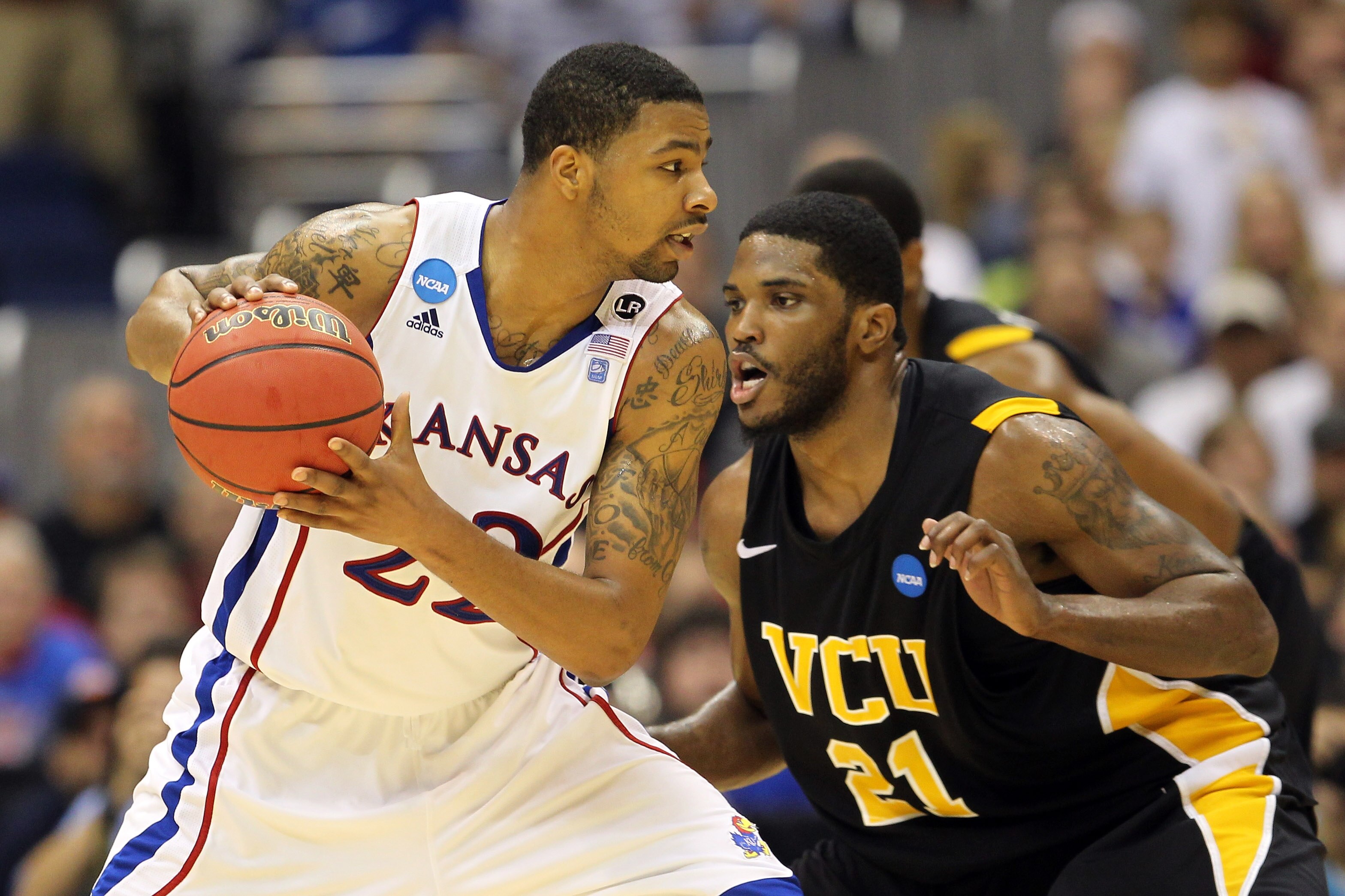 SAN ANTONIO, TX - MARCH 27:  Marcus Morris #22 of the Kansas Jayhawks handles the ball against Jamie Skeen #21 of the Virginia Commonwealth Rams during the southwest regional final of the 2011 NCAA men's basketball tournament at the Alamodome on March 27,