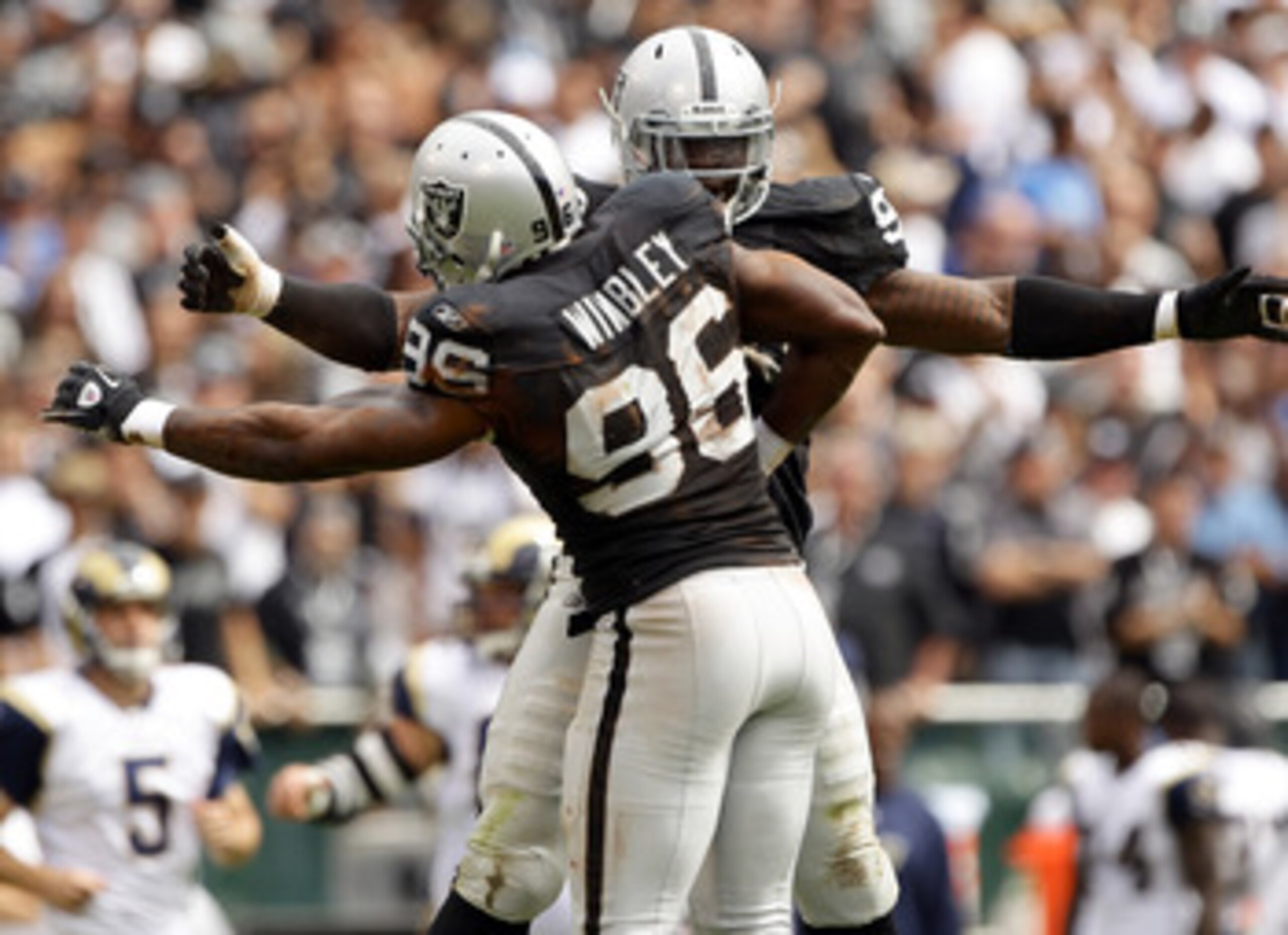 OAKLAND, CA - SEPTEMBER 19:  Lamarr Houston #99 is congratulated by Kamerion Wimbley #96 of the Oakland Raiders after Houston sacked Sam Bradford #8 of the St. Louis Rams at the Oakland-Alameda County Coliseum on September 19, 2010 in Oakland, California.