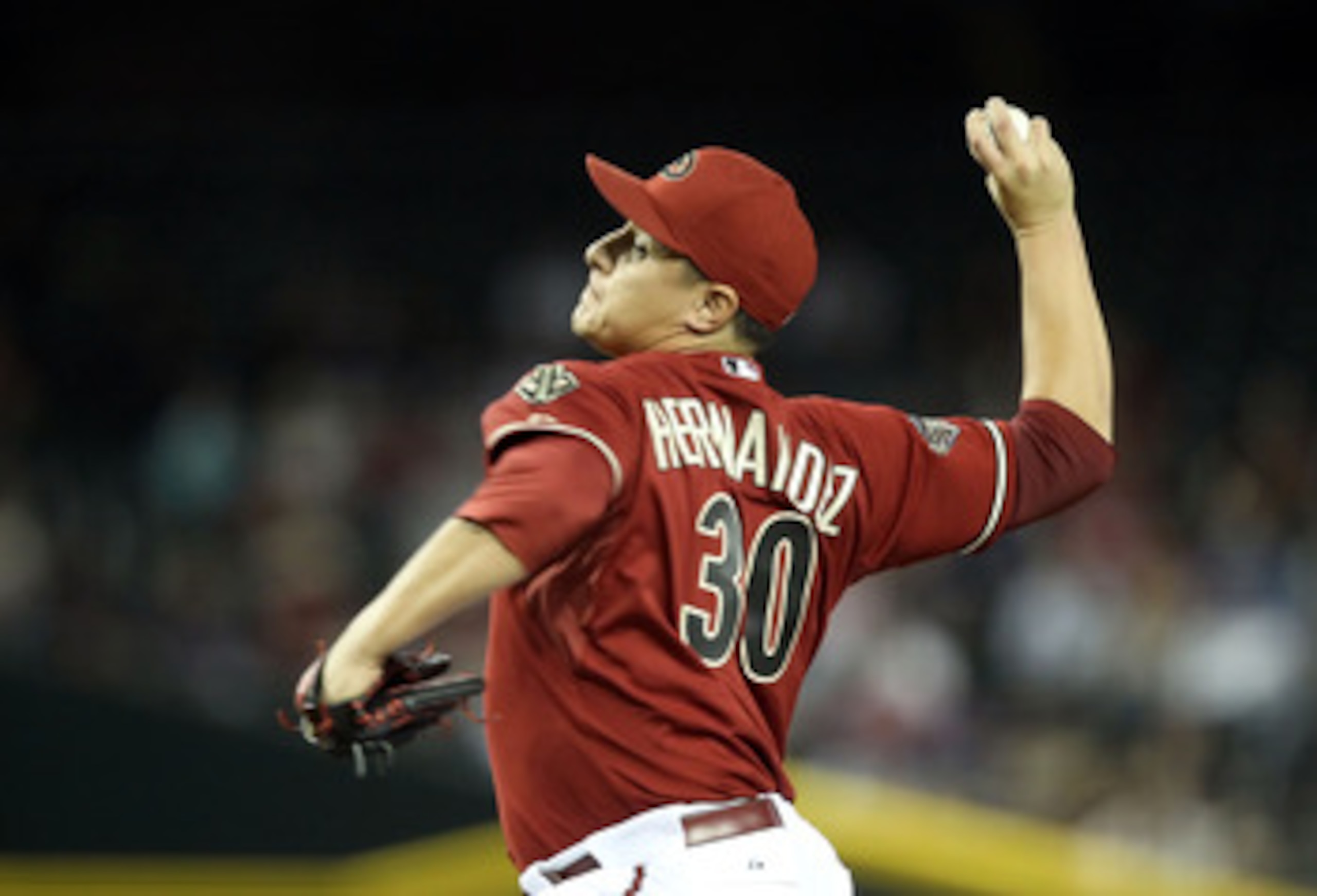 PHOENIX, AZ - MAY 18:  Relief pitcher David Hernandez #30 of the Arizona Diamondbacks pitches against the Atlanta Braves during the Major League Baseball game at Chase Field on May 18, 2011 in Phoenix, Arizona.  The Diamondbacks defeated the Braves 5-4 in