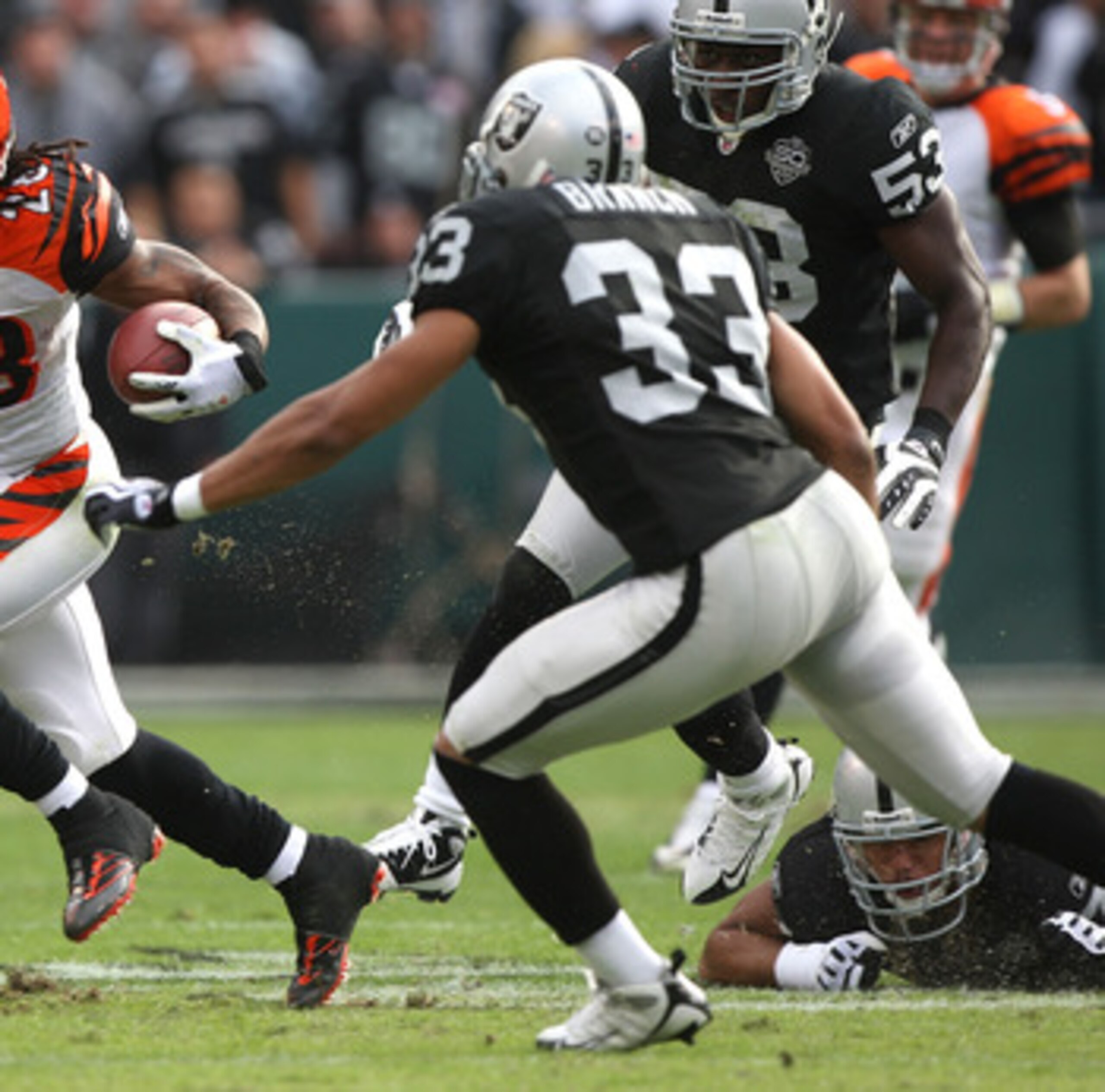 OAKLAND, CA - NOVEMBER 22: Bernard Scott #28 of the Cincinnati Bengals runs against Tyvon Branch #33 of the Oakland Raiders during an NFL game at Oakland-Alameda County Coliseum on November 22, 2009 in Oakland, California.  (Photo by Jed Jacobsohn/Getty I