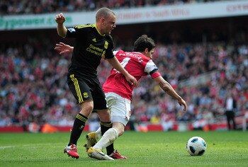 LONDON, ENGLAND - APRIL 17: Jay Spearing of Liverpool tackles Cesc Fabregas of Arsenal and gives away a penalty kick during the Barclays Premier League match between Arsenal and Liverpool at the Emirates Stadium on April 17, 2011 in London, England. (Ph LONDON, ENGLAND - APRIL 17: Jay Spearing of Liverpool tackles Cesc Fabregas of Arsenal and gives away a penalty kick during the Barclays Premier League match between Arsenal and Liverpool at the Emirates Stadium on April 17, 2011 in London, England. (Ph
