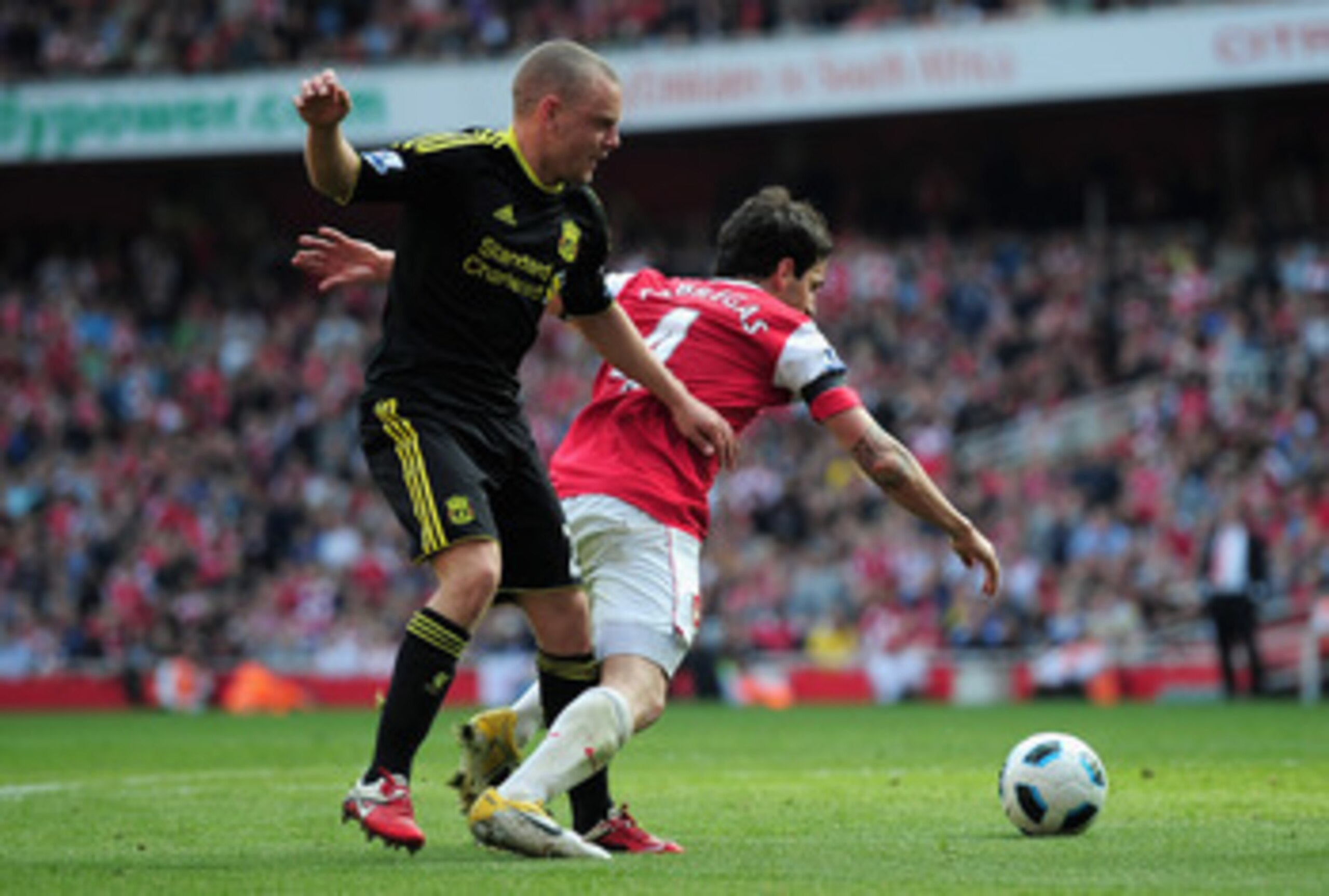 LONDON, ENGLAND - APRIL 17:  Jay Spearing of Liverpool tackles Cesc Fabregas of Arsenal and gives away a penalty kick during the Barclays Premier League match between Arsenal and Liverpool at the Emirates Stadium on April 17, 2011 in London, England.  (Ph