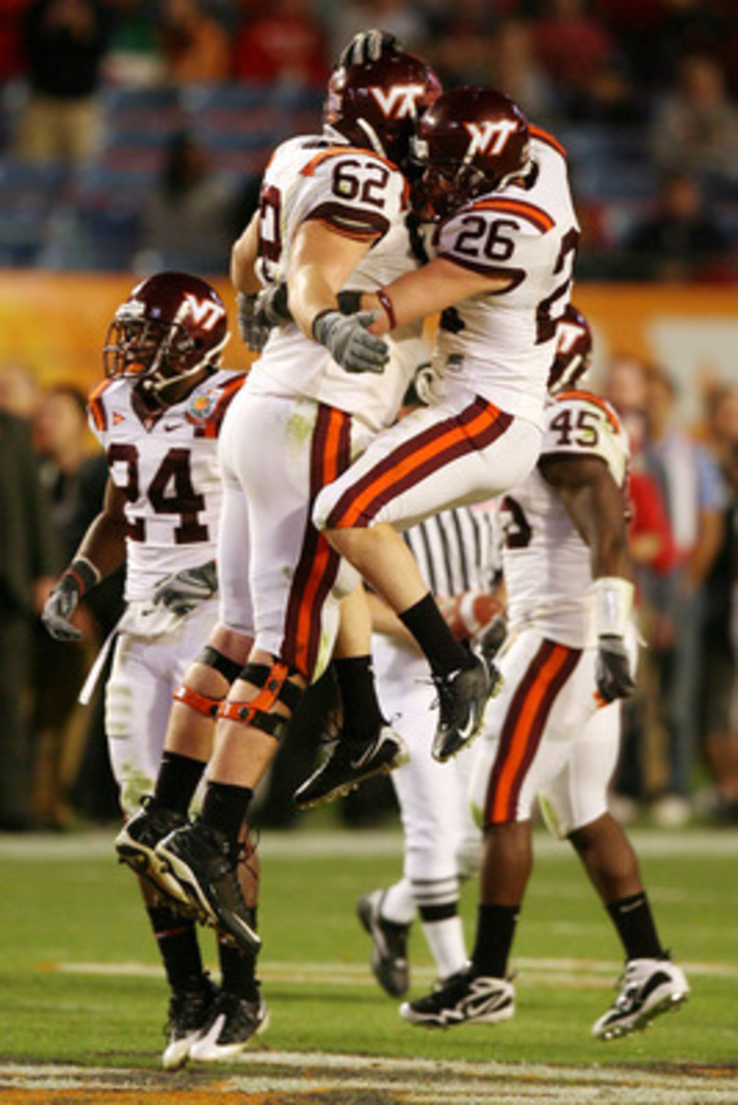 MIAMI - JANUARY 01:  Blake DeChristopher #62 and  Cody Grimm #26 of the Virginia Tech Hokies celebrates against the Cincinnati Bearcats during the FedEx Orange Bowl at Dolphin Stadium on January 1, 2009 in Miami, Florida.  (Photo by Doug Benc/Getty Images