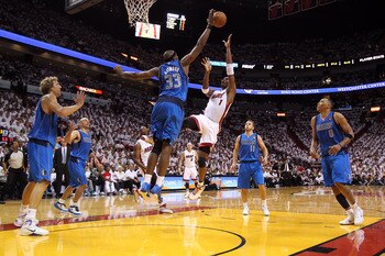 MIAMI, FL - MAY 31:  Chris Bosh #1 of the Miami Heat shoots over Brendan Haywood #33 of the Dallas Mavericks in the second half in Game One of the 2011 NBA Finals at American Airlines Arena on May 31, 2011 in Miami, Florida. NOTE TO USER: User expressly a